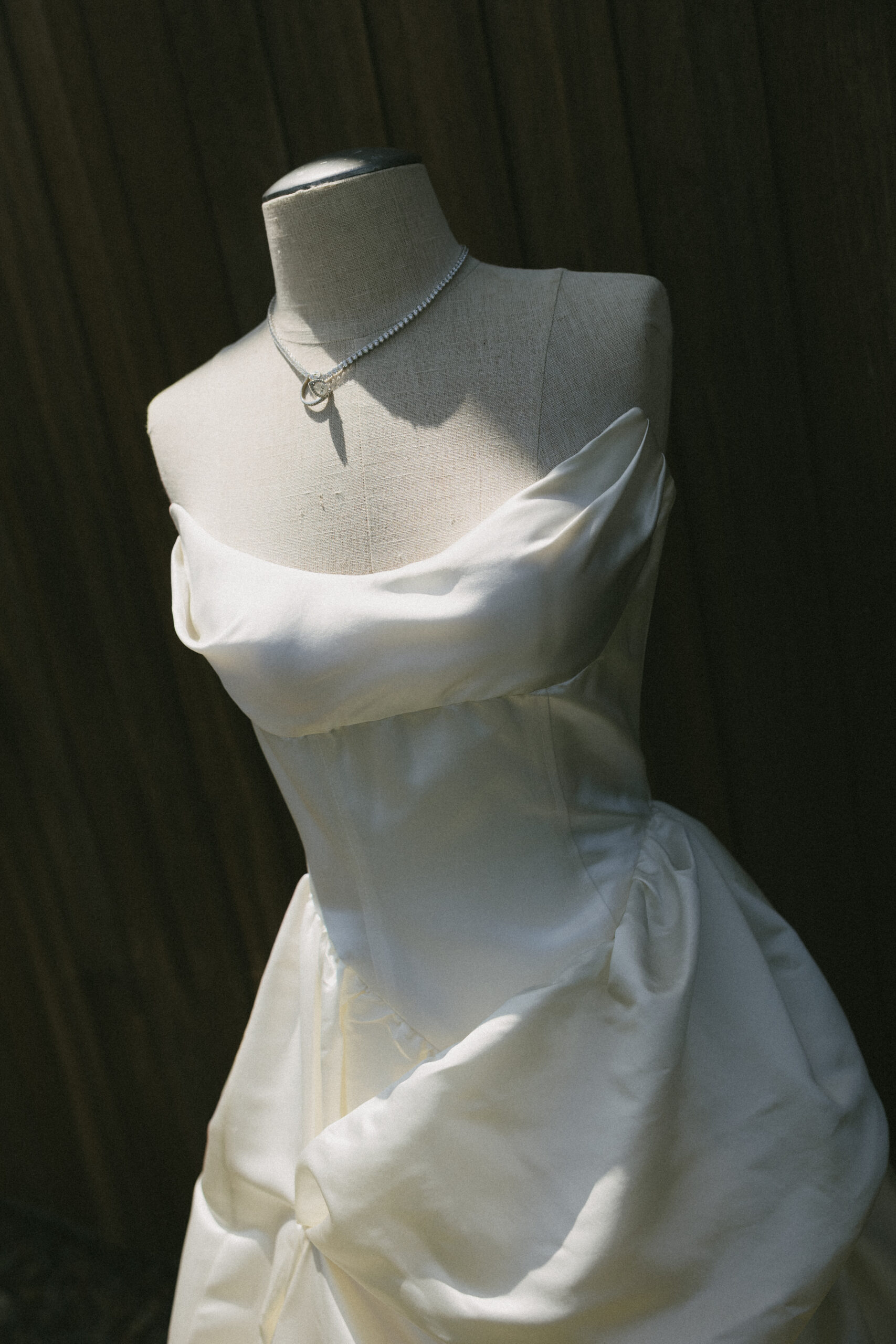 Wedding detail photo of bride's wedding dress on a mannequin