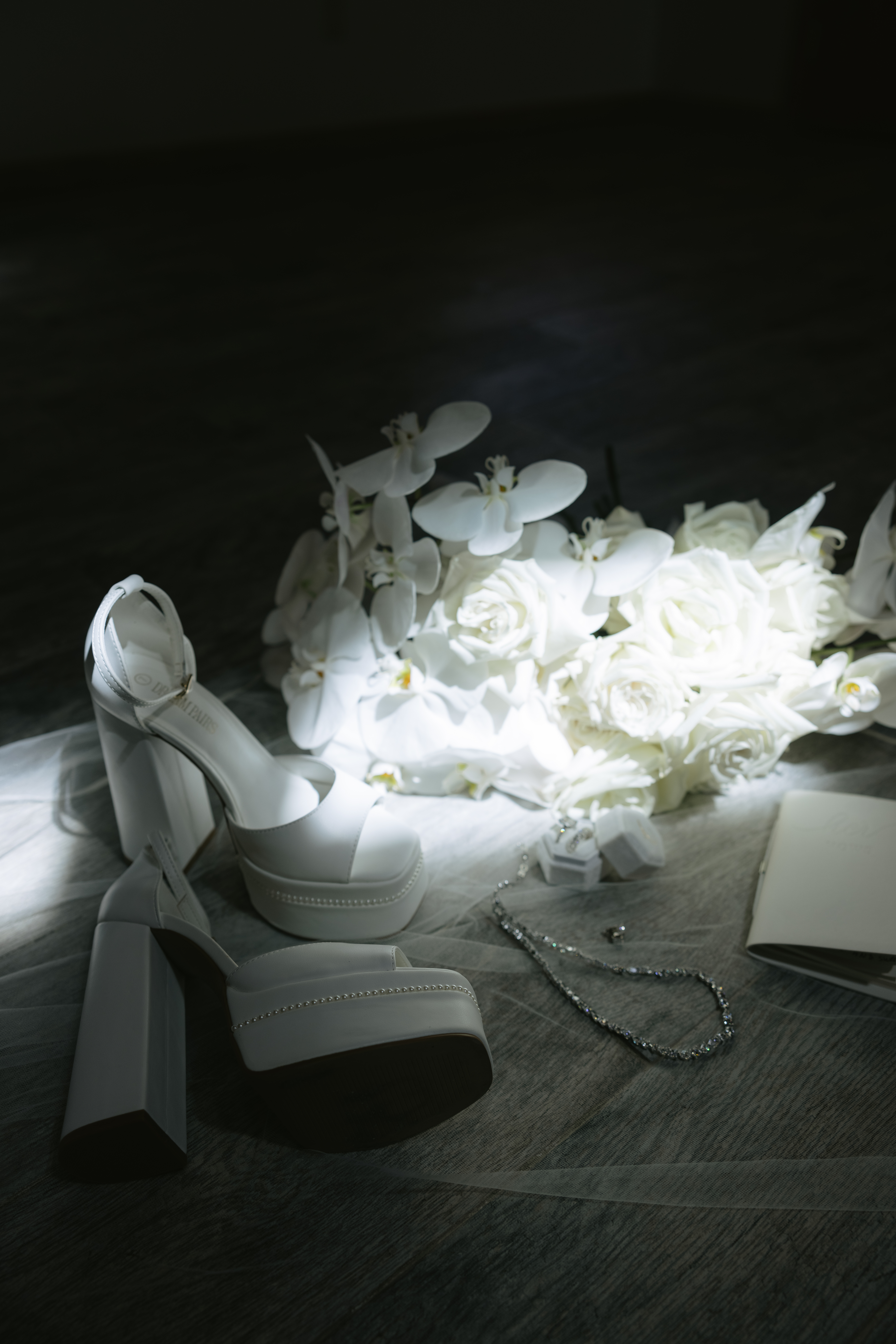 Wedding shoes, jewelry, and flowers in a wedding flat lay photo