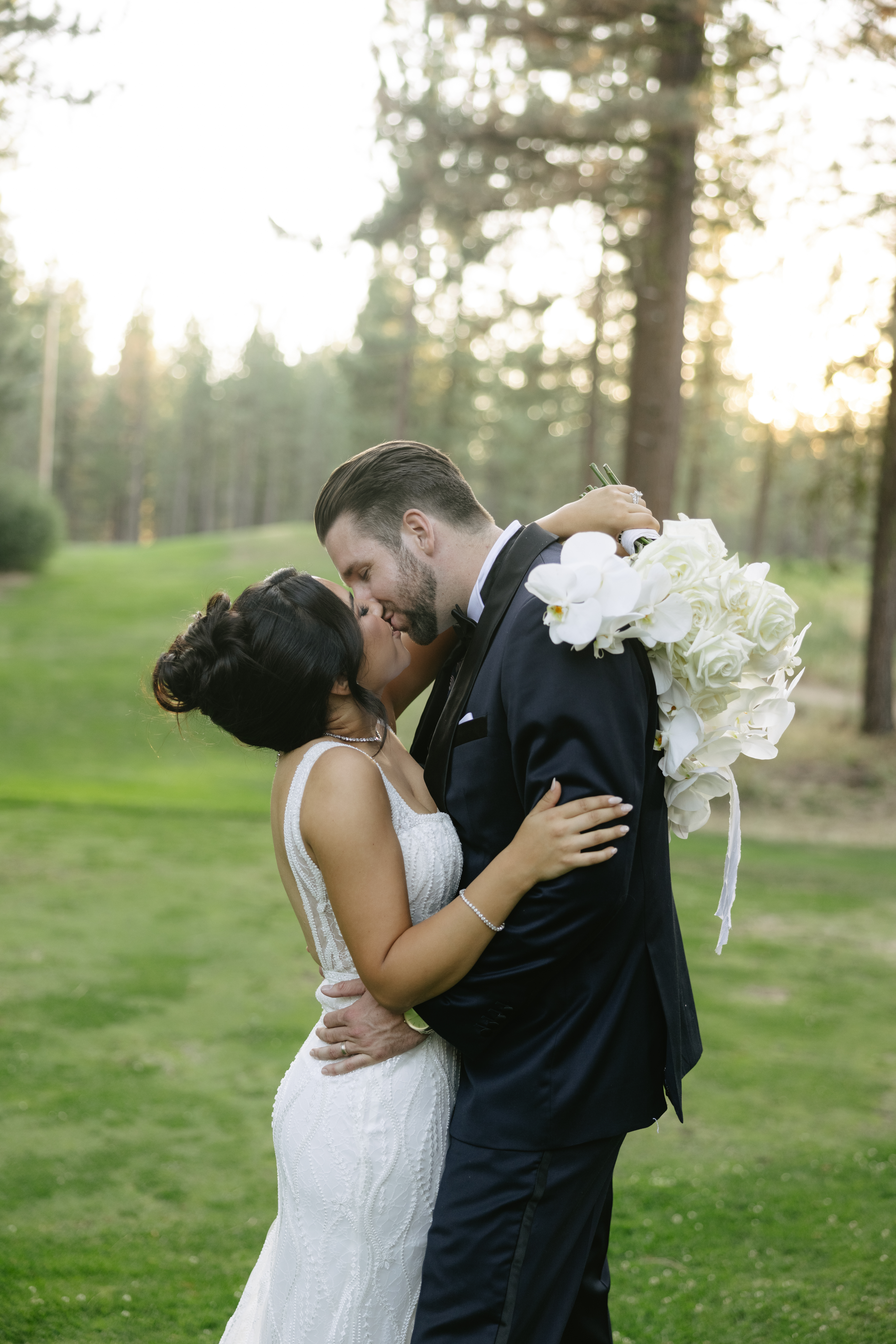 Bride and groom kissing during wedding portraits