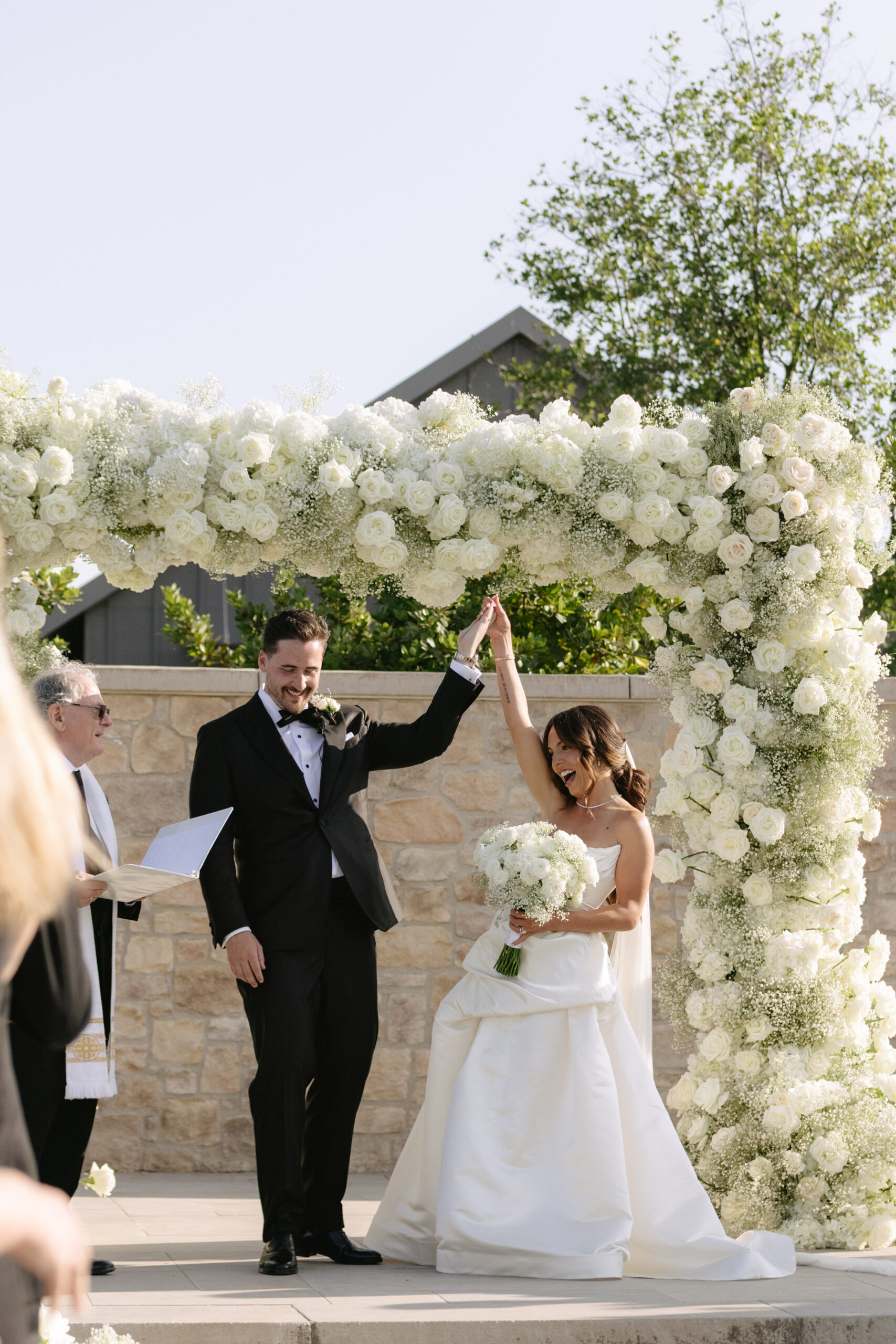 Bride and groom cheering after their wedding ceremony