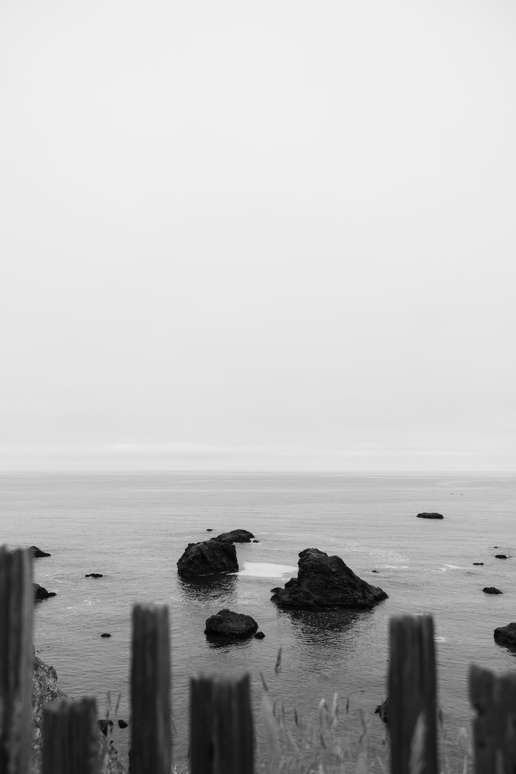 Black and white photo of the ocean rocks on the California coast