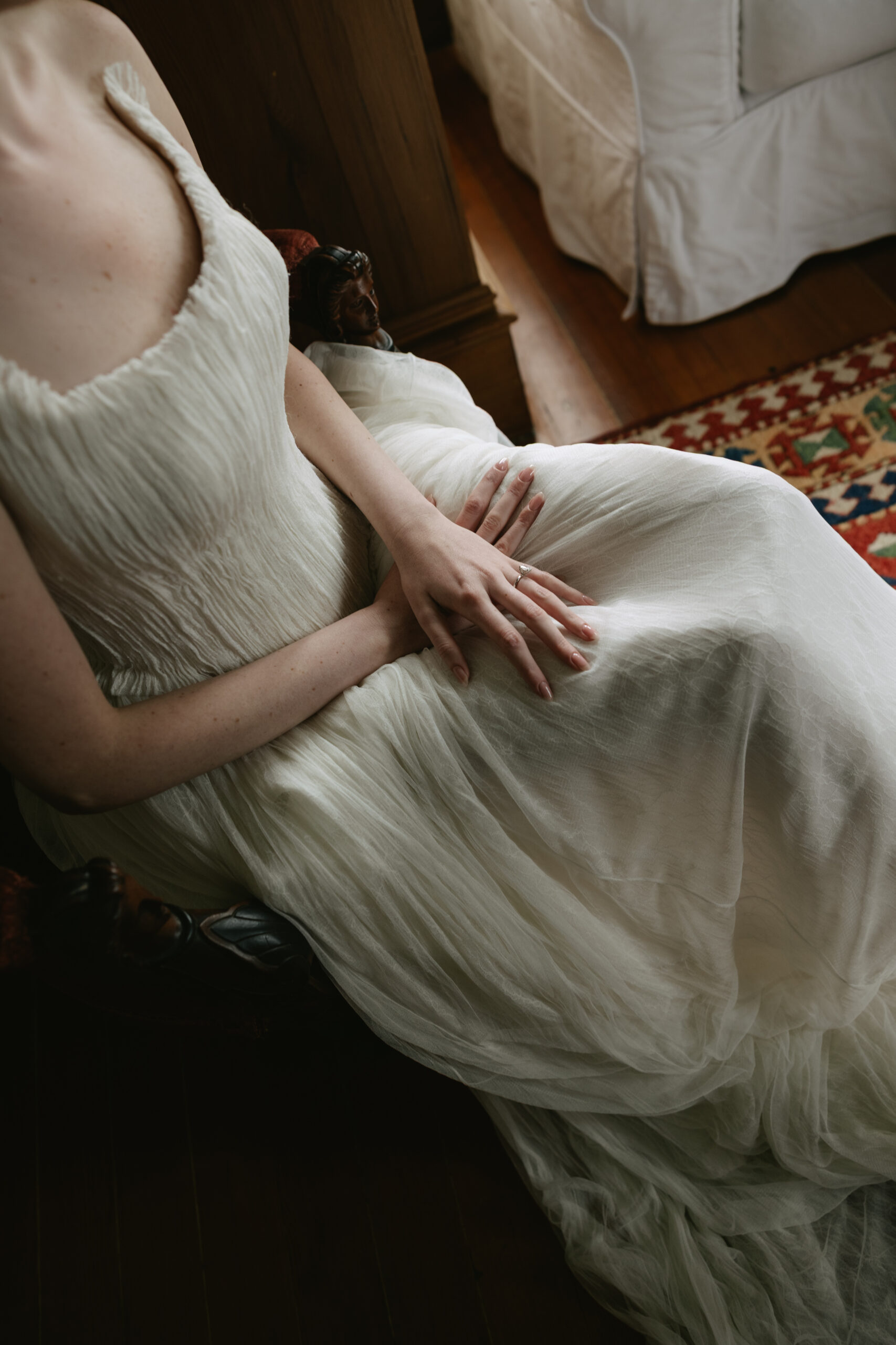 Bride sitting after putting on her textured wedding dress