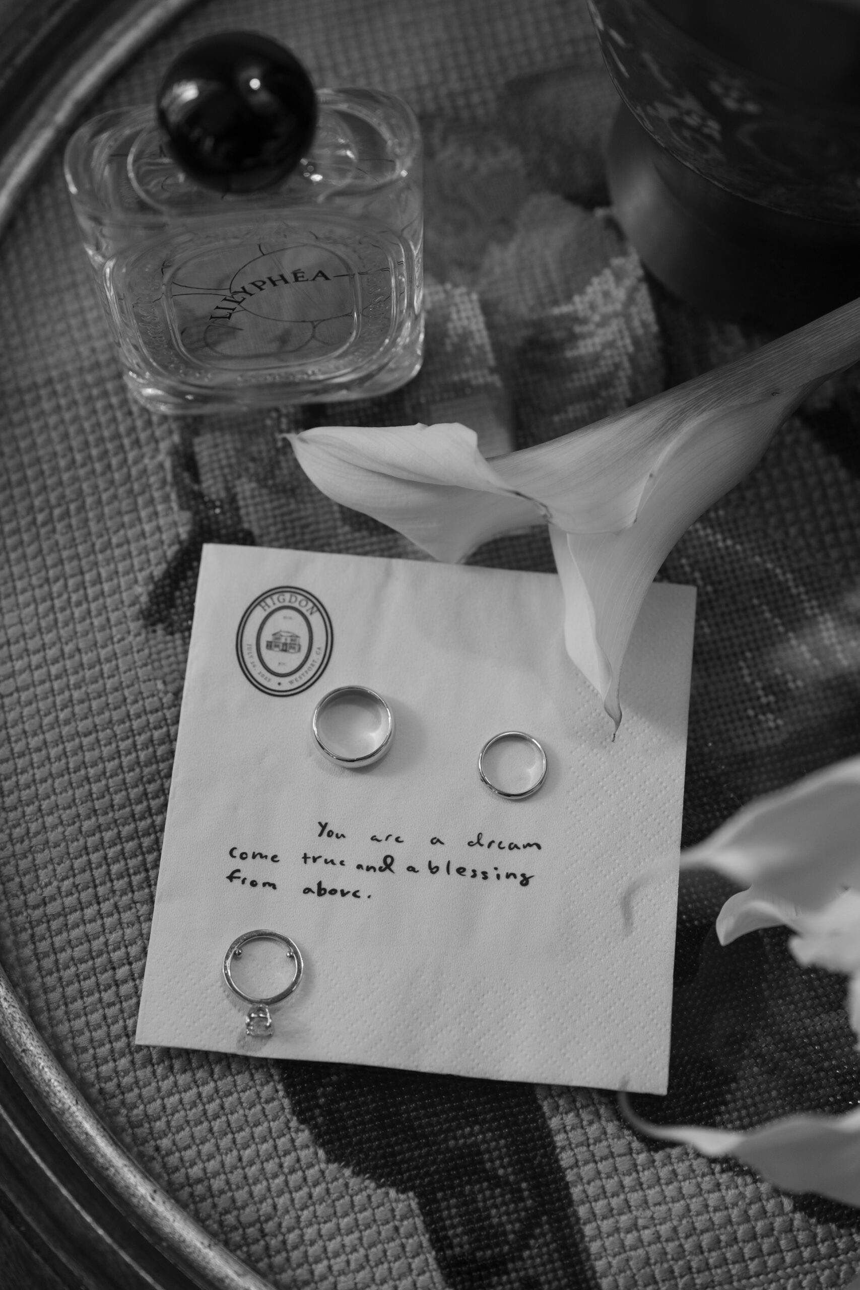 A napkin with a love note and a single calla lily as wedding details