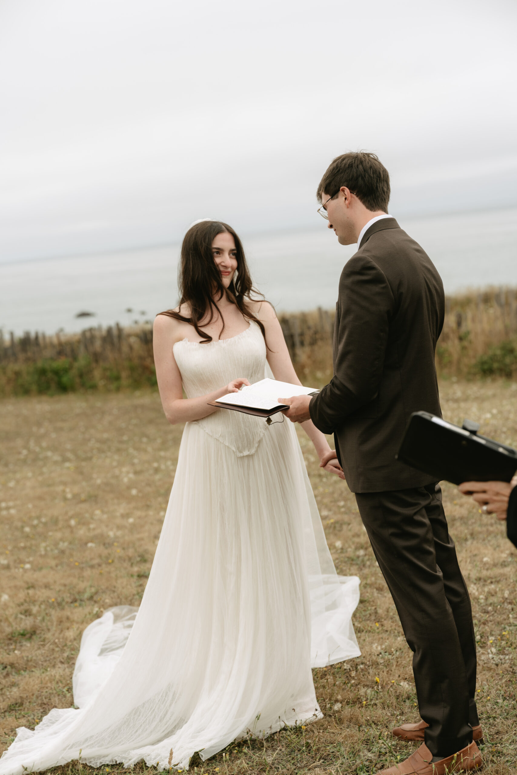 Bride smiling at groom during vow reading