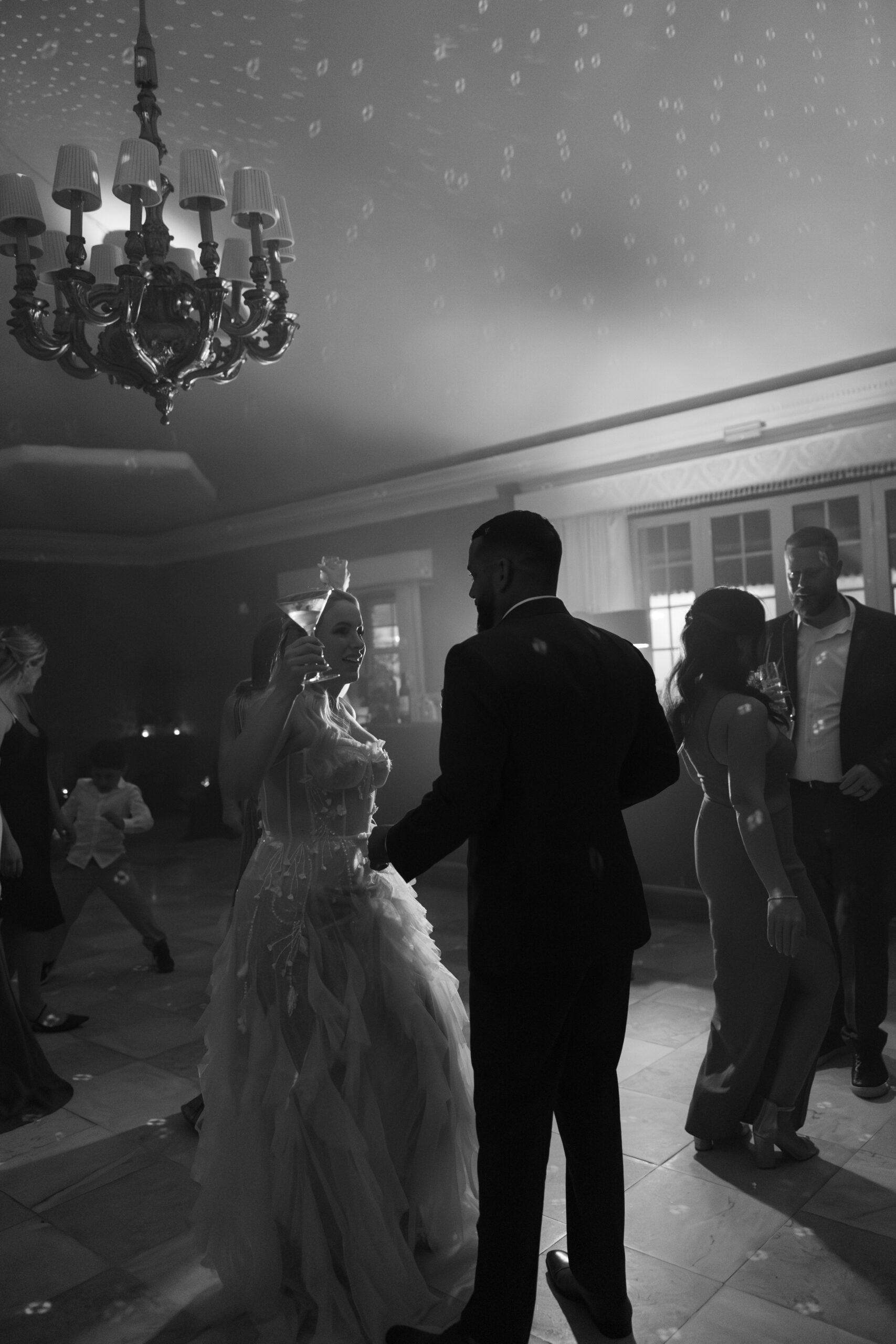 Black and white photo of bride and groom dancing at their wedding reception