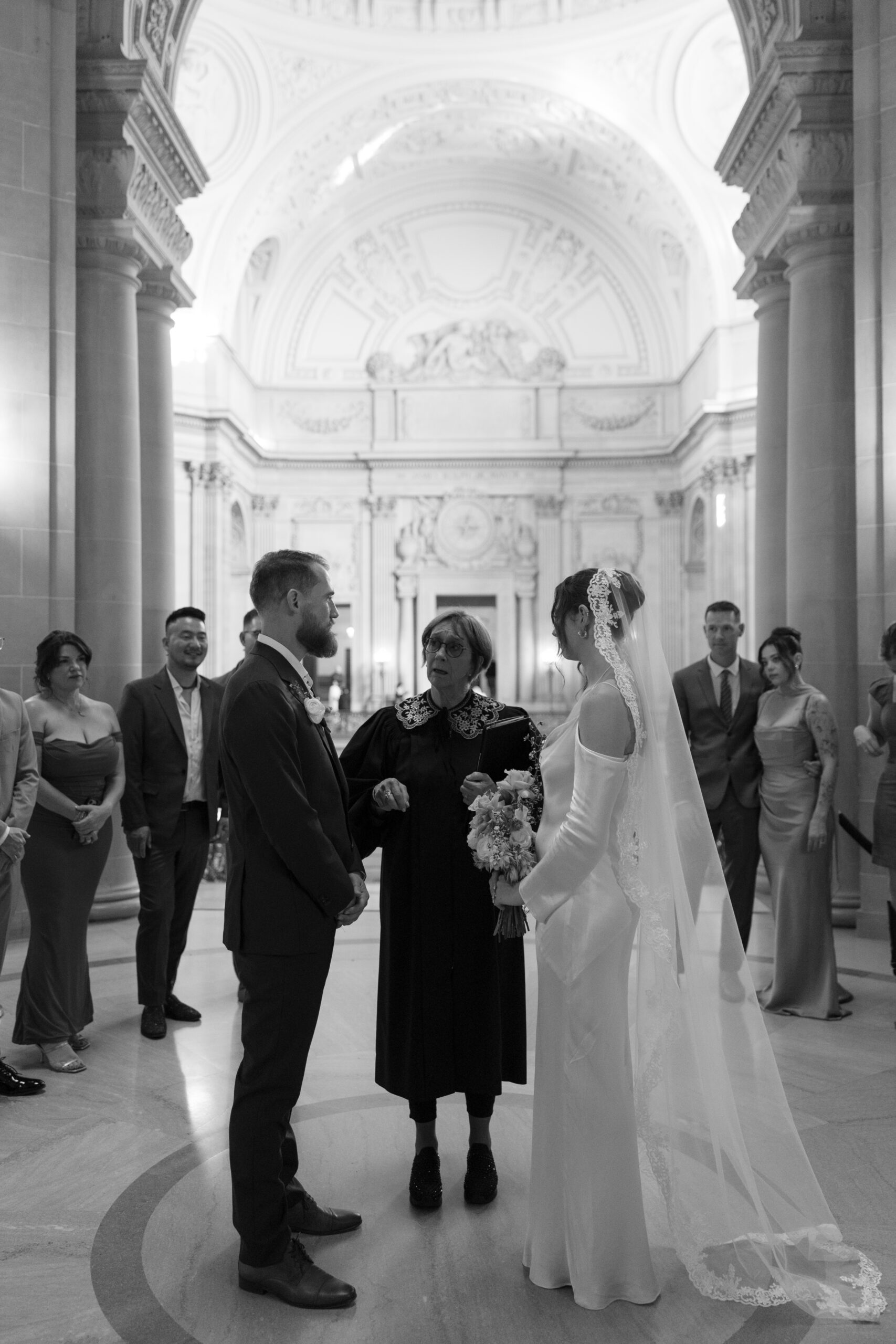 A couple standing for their San Francisco City Hall wedding