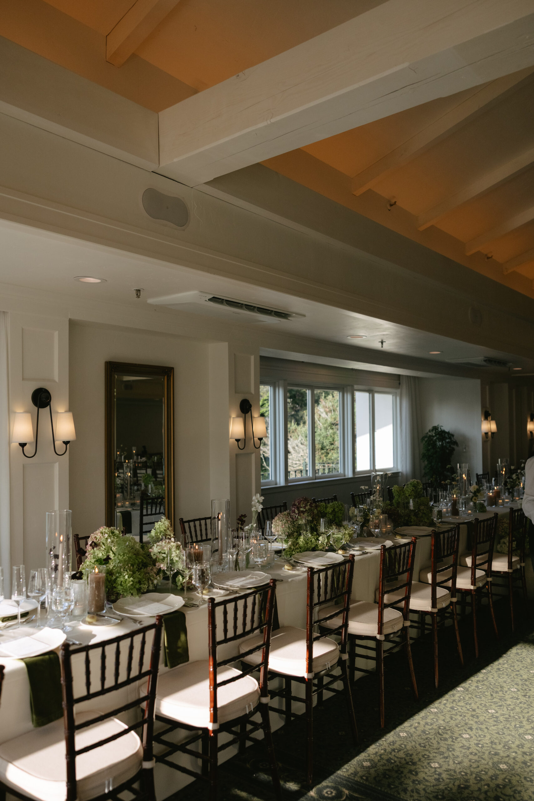 The inside of the Pacific Room at La Playa Hotel with white walls and a wedding reception setup