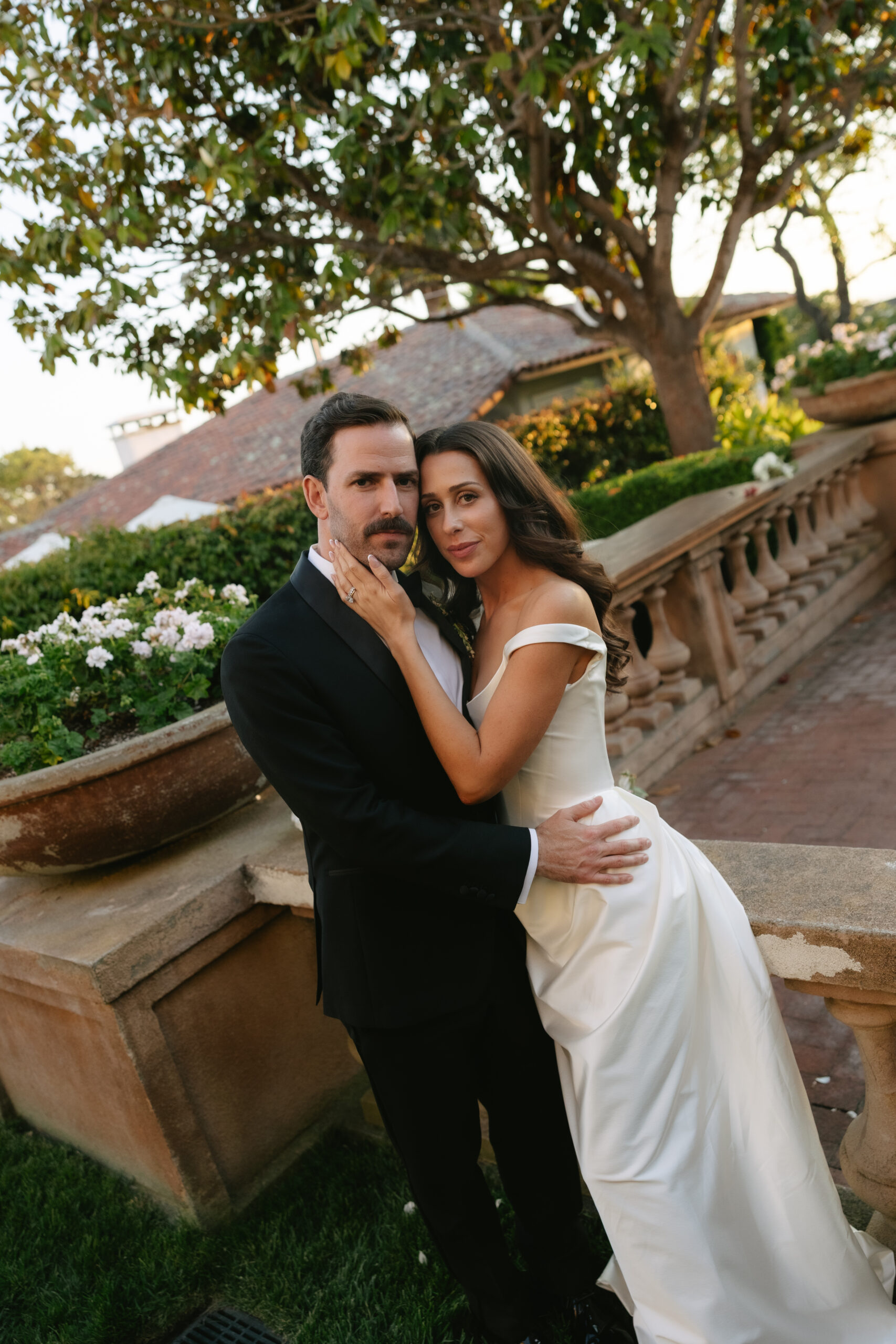 Bride and groom posing at Italian-esque wedding venue, La Playa Hotel
