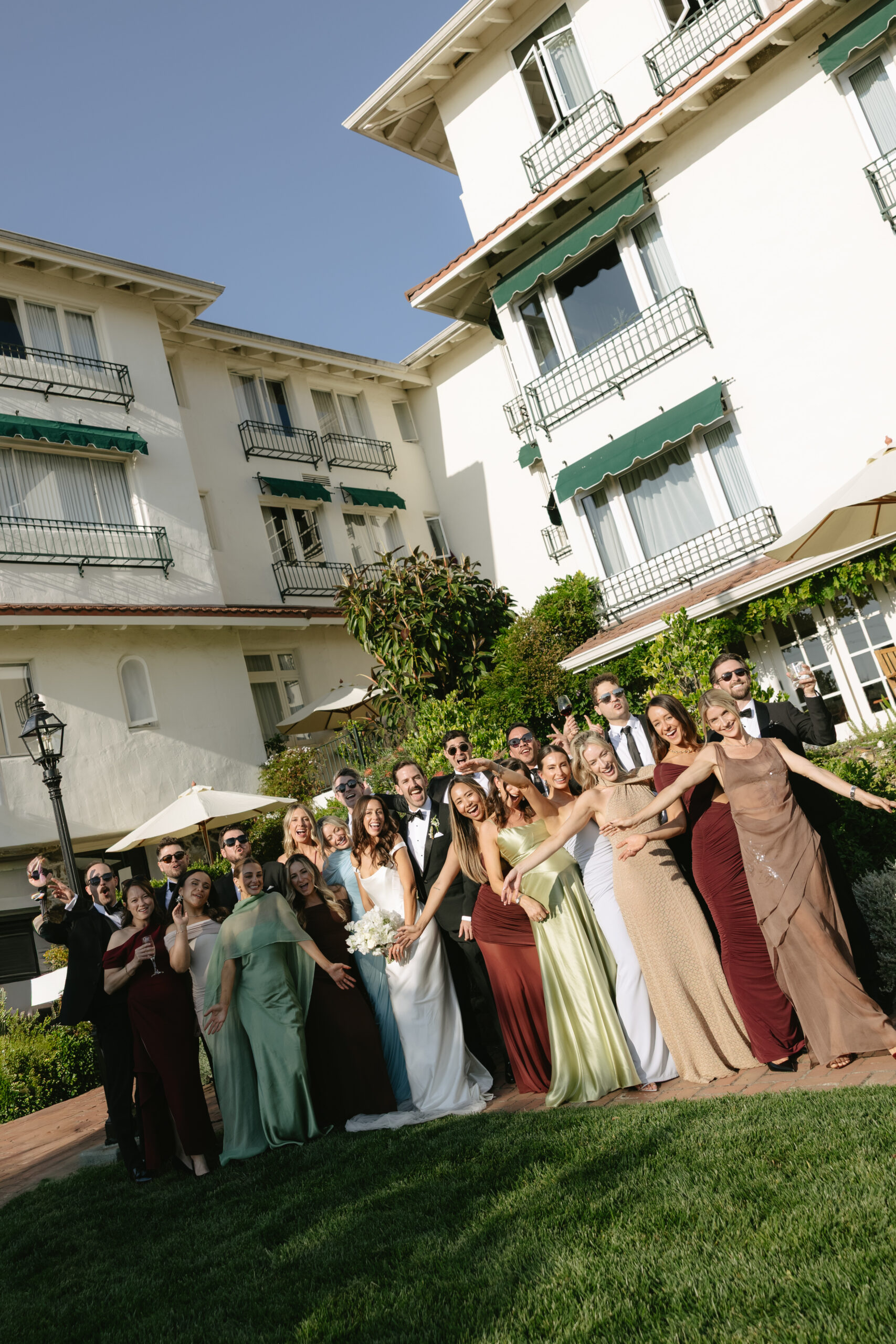 Wedding party posing for wedding photos in front of La Playa Hotel