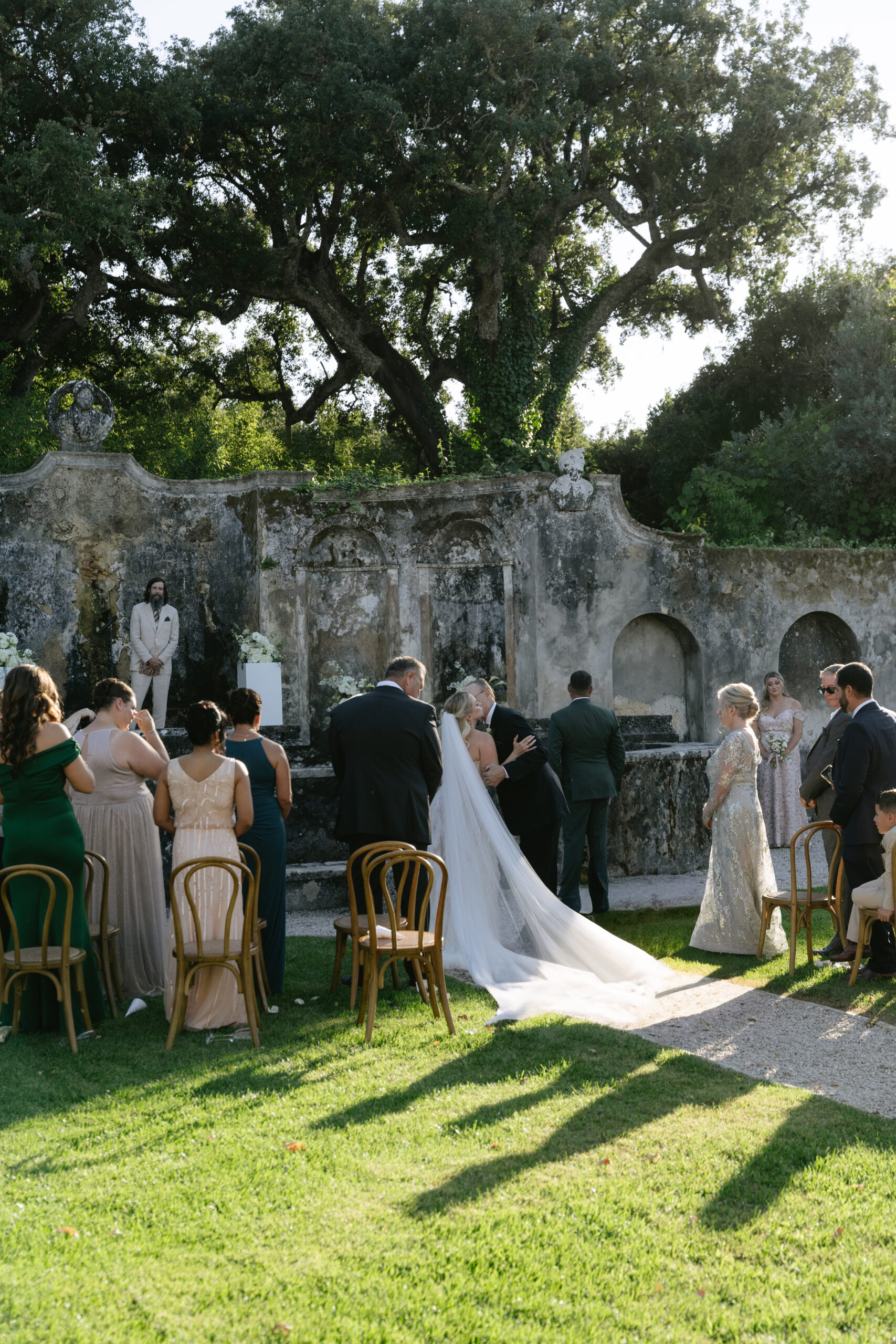 Bride's dad hugging and kissing her on the cheek after walking down tha aisle