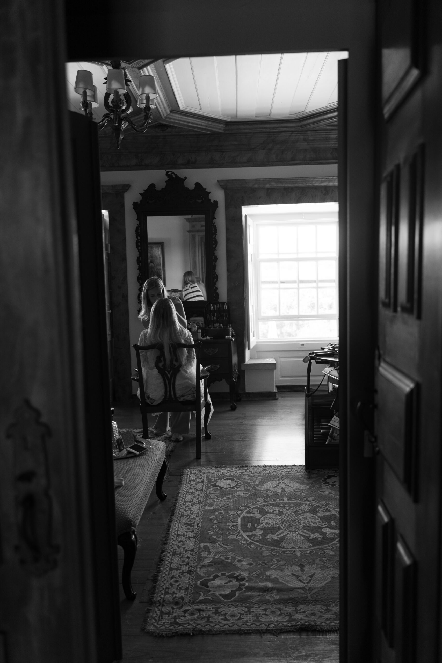 Black and white photo of bride getting ready for her wedding