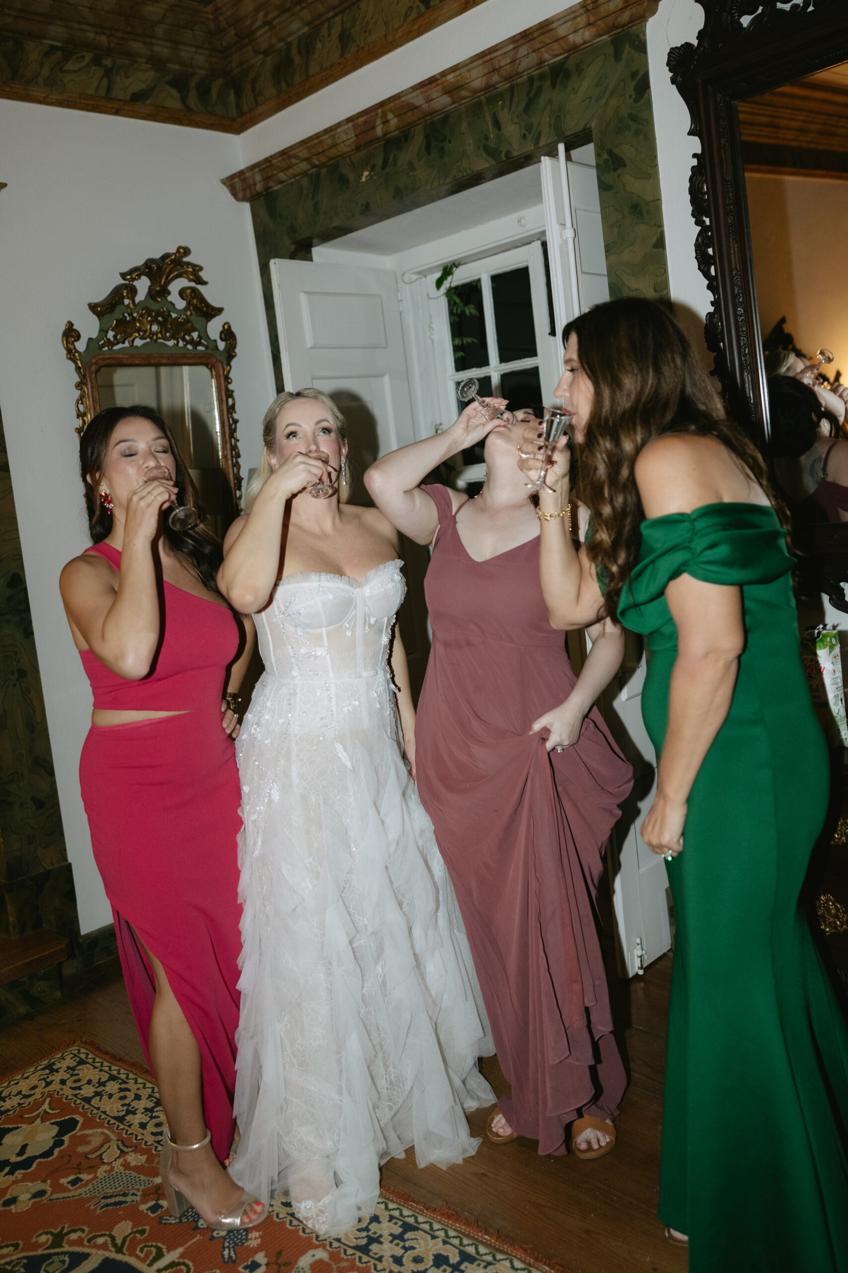 Bride and wedding party taking shots at wedding reception