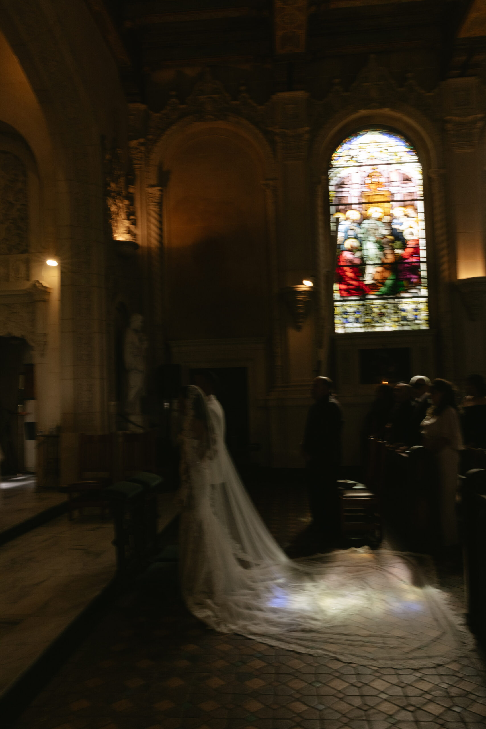 A blurry photo of a ceremony from a Catholic wedding
