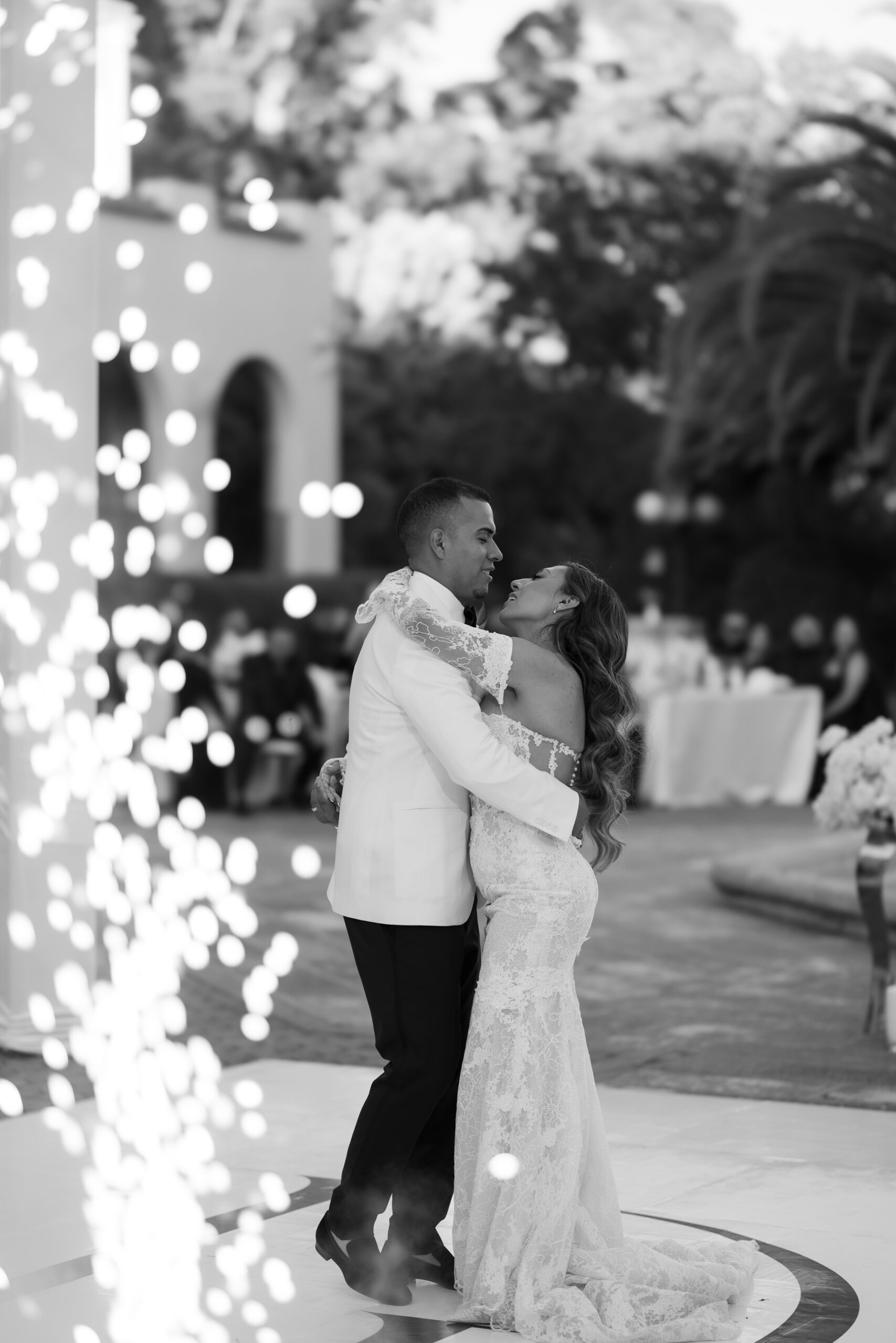 A wedding couple dancing with fireworks at their wedding reception