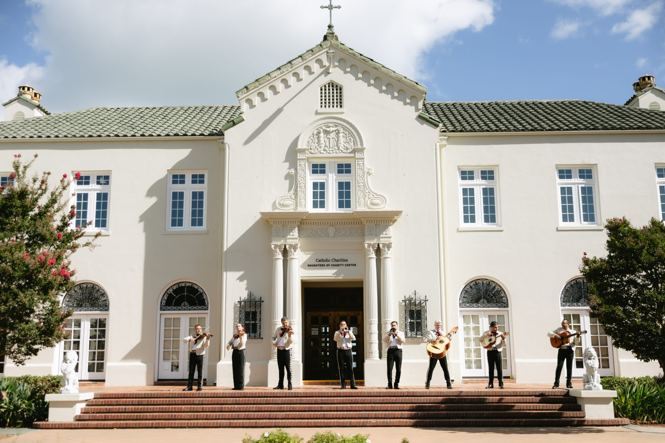A mariachi band performing for a Catholic wedding at an outdoor reception