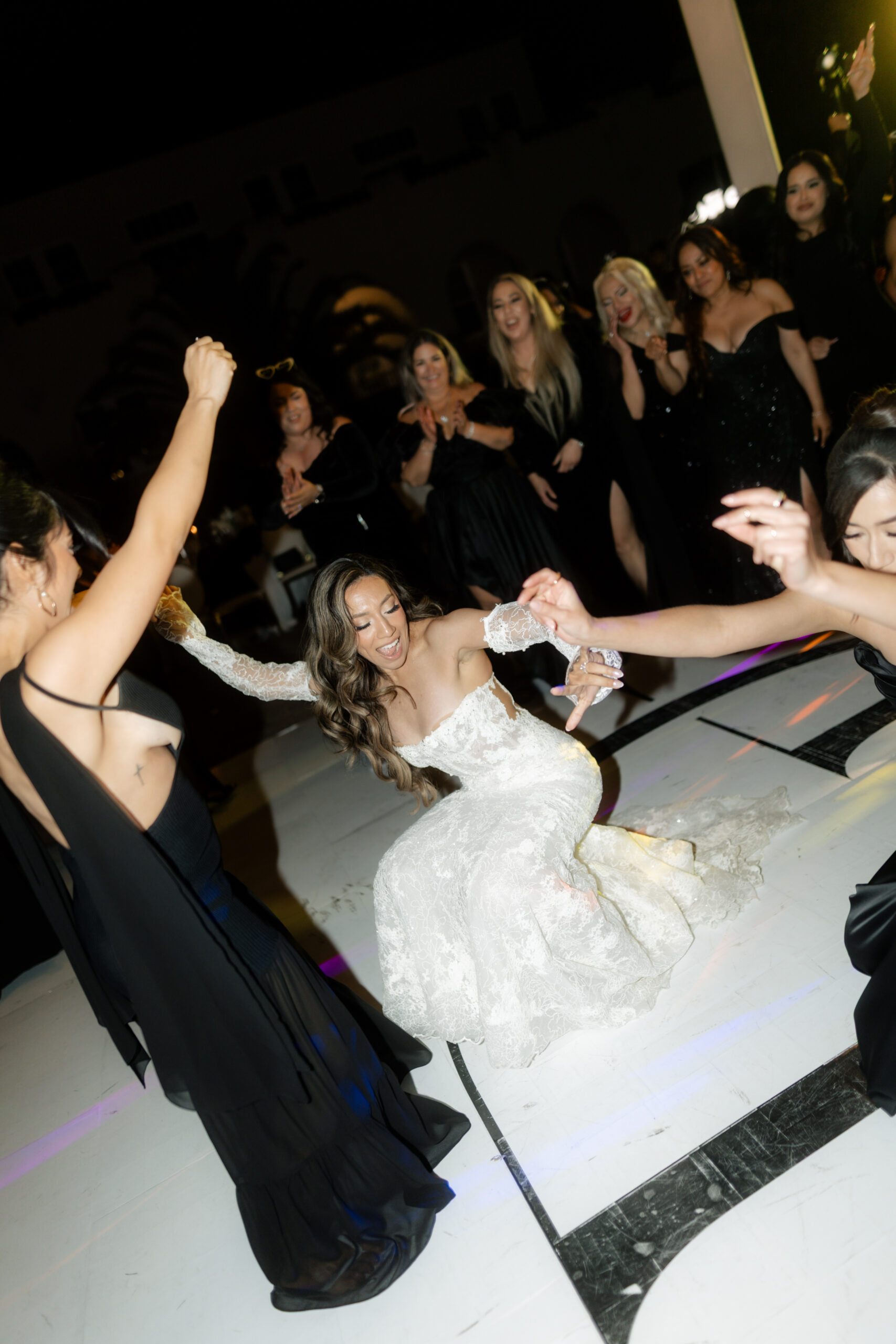 A candid wedding photo of a bride dancing at her wedding reception