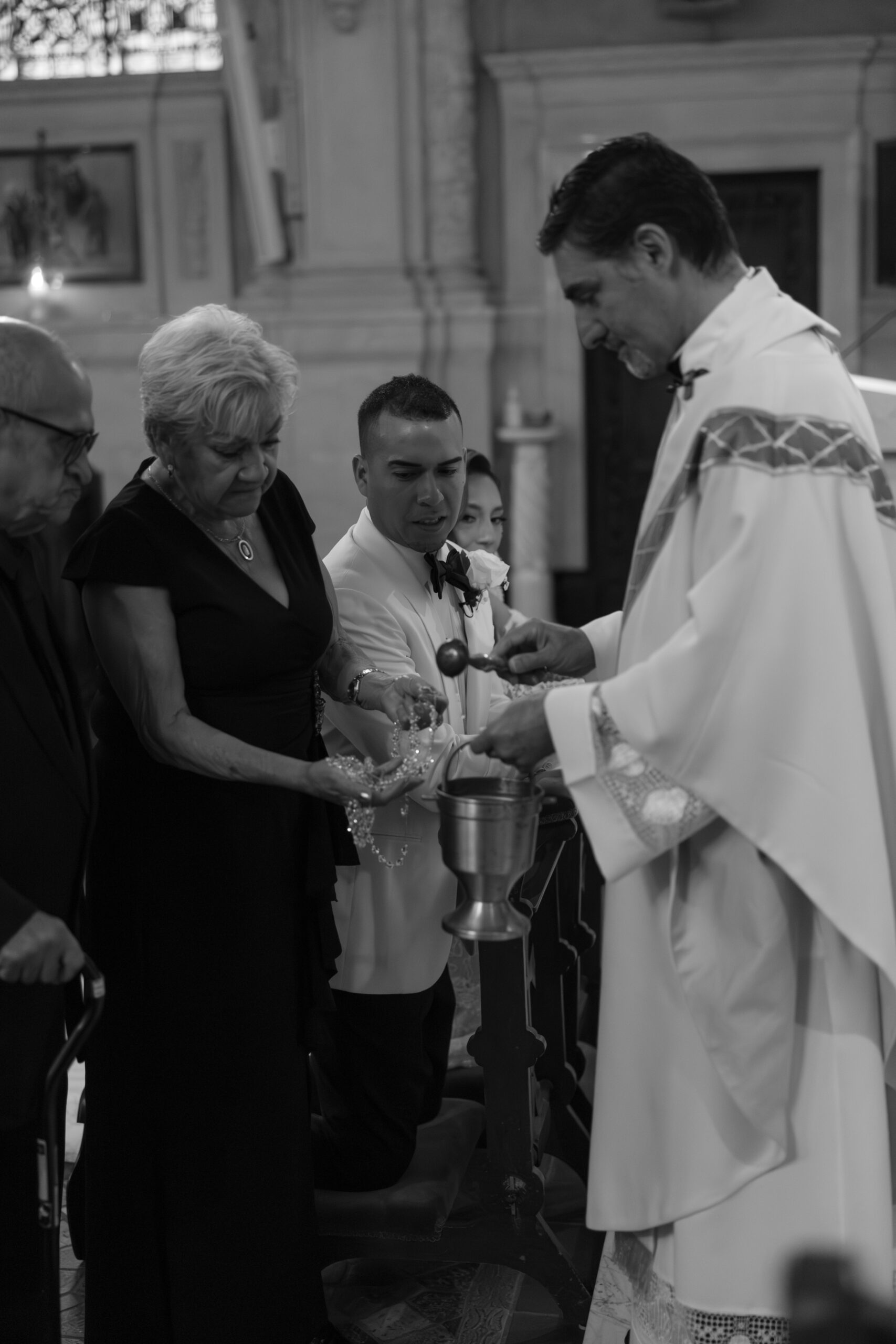 A candid photo of communion during a ceremony, traditional for Catholic weddings