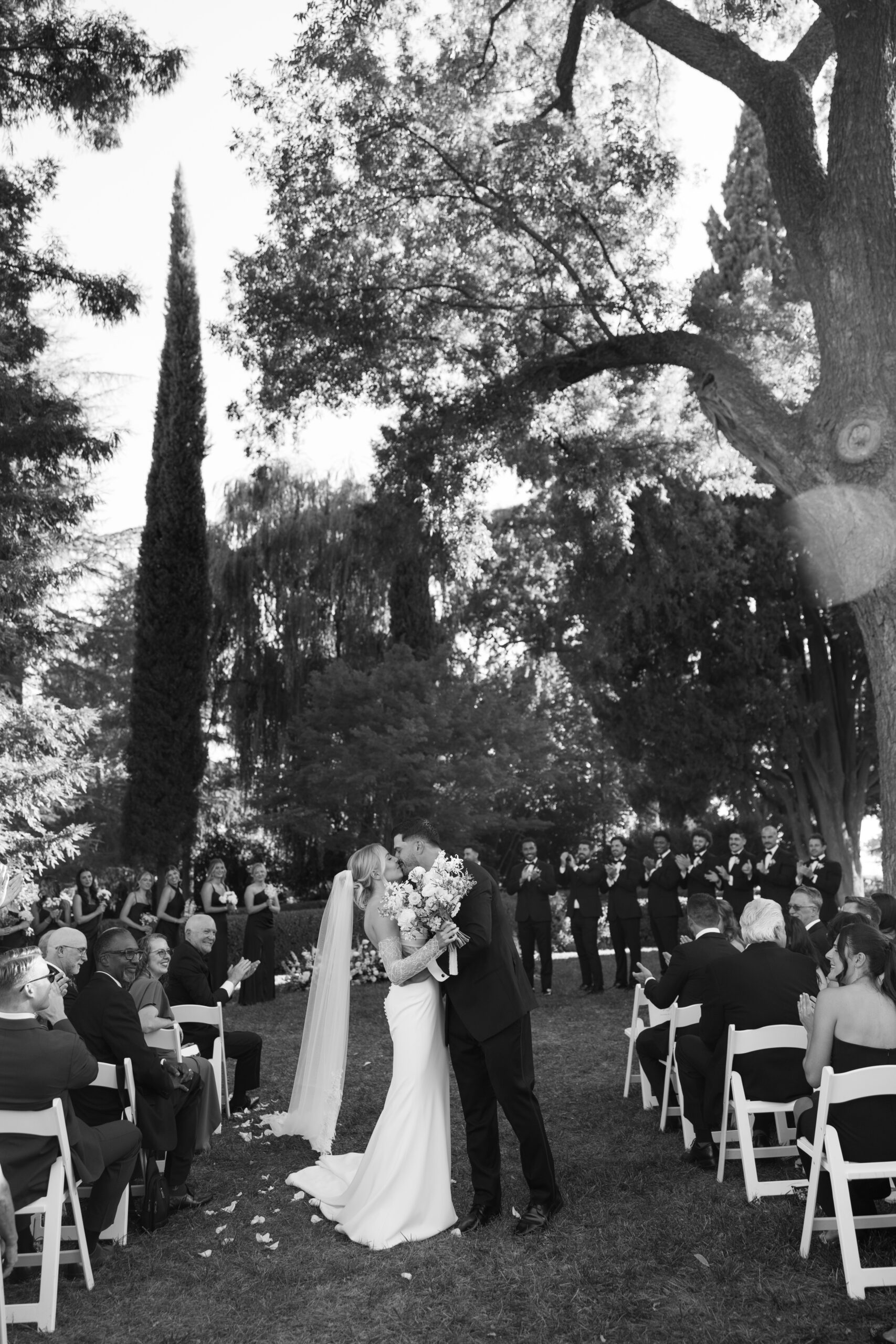 A couple kissing while exiting their wedding ceremony