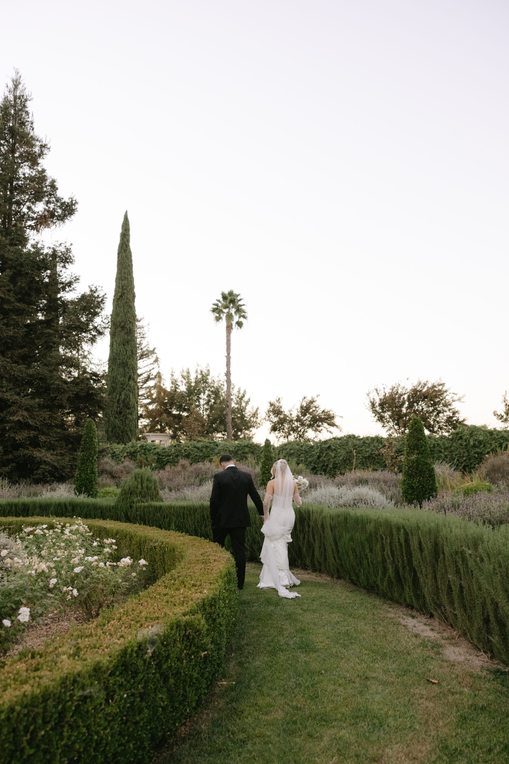 A couple walking through the gardens at Park Winters