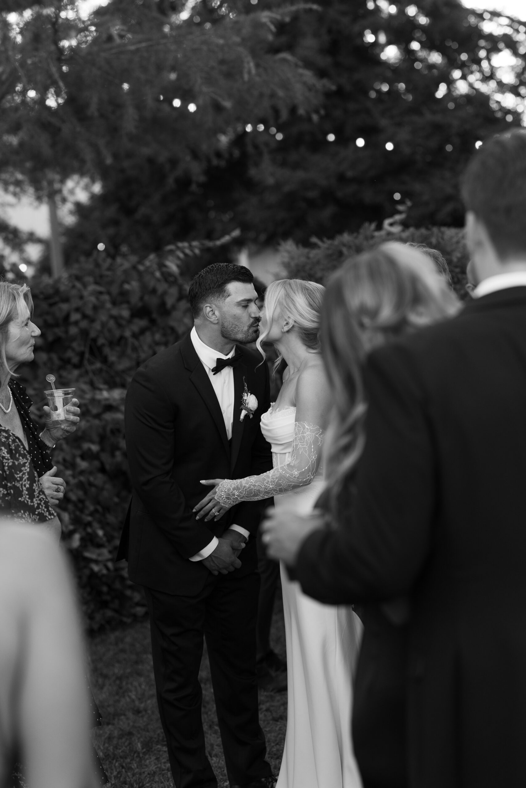 A couple kissing in a candid wedding photo