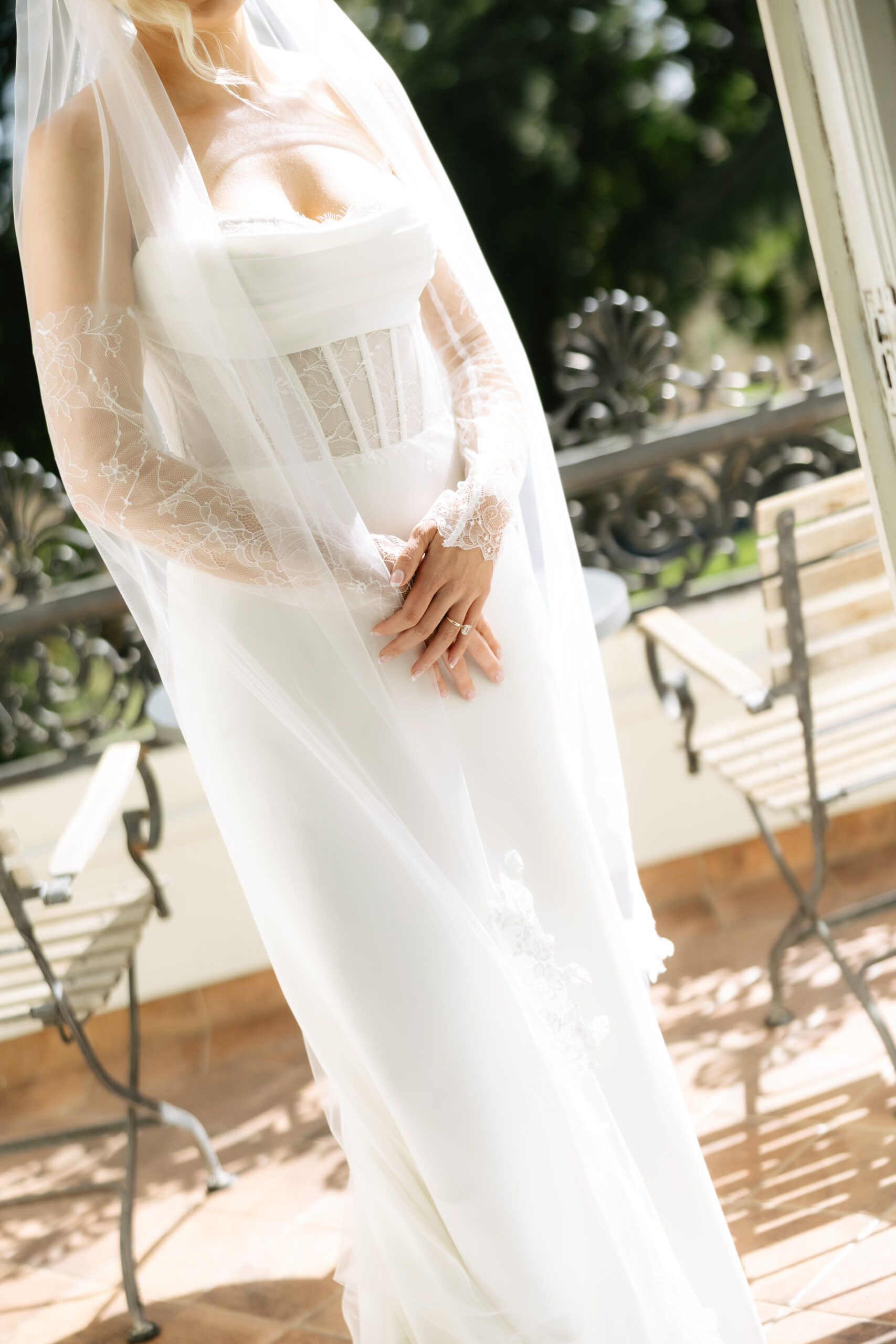 An up close photo of a bride's wedding dress and veil