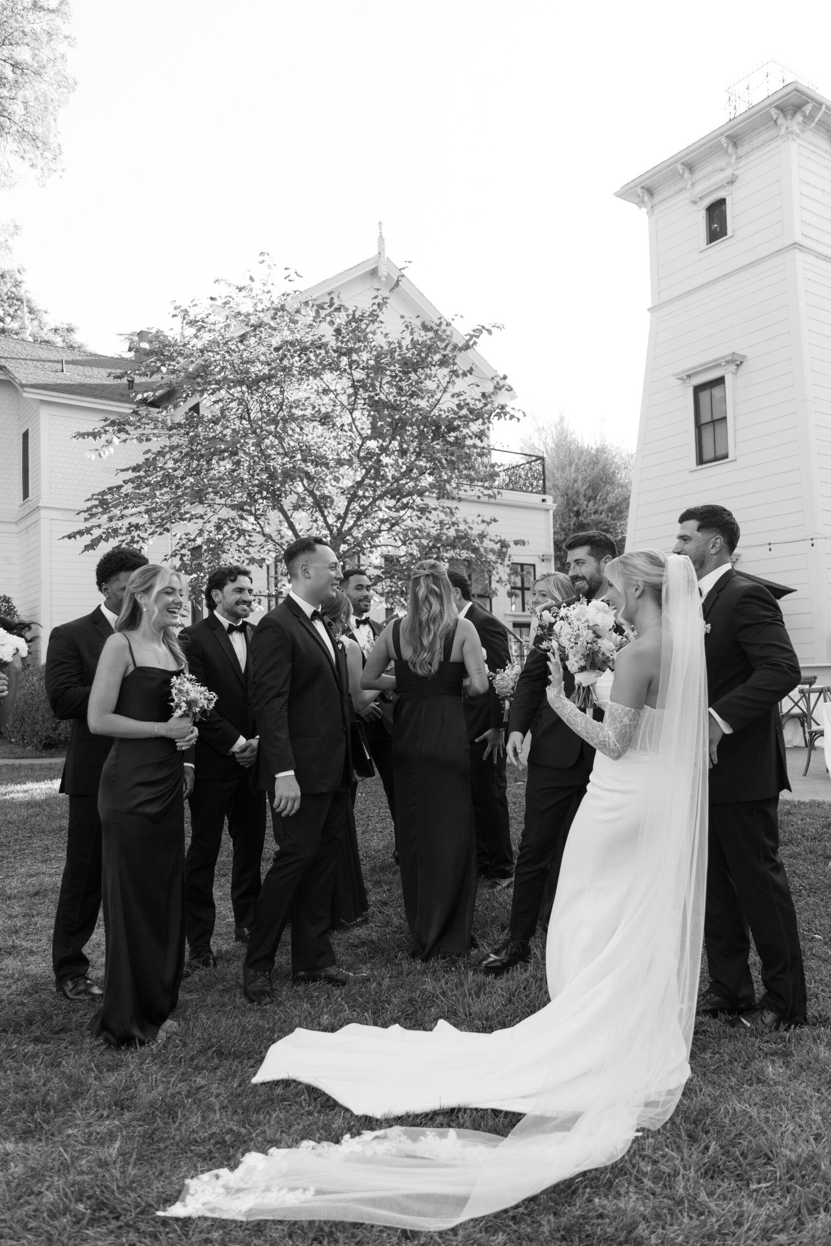 A wedding couple talking to their bridal party