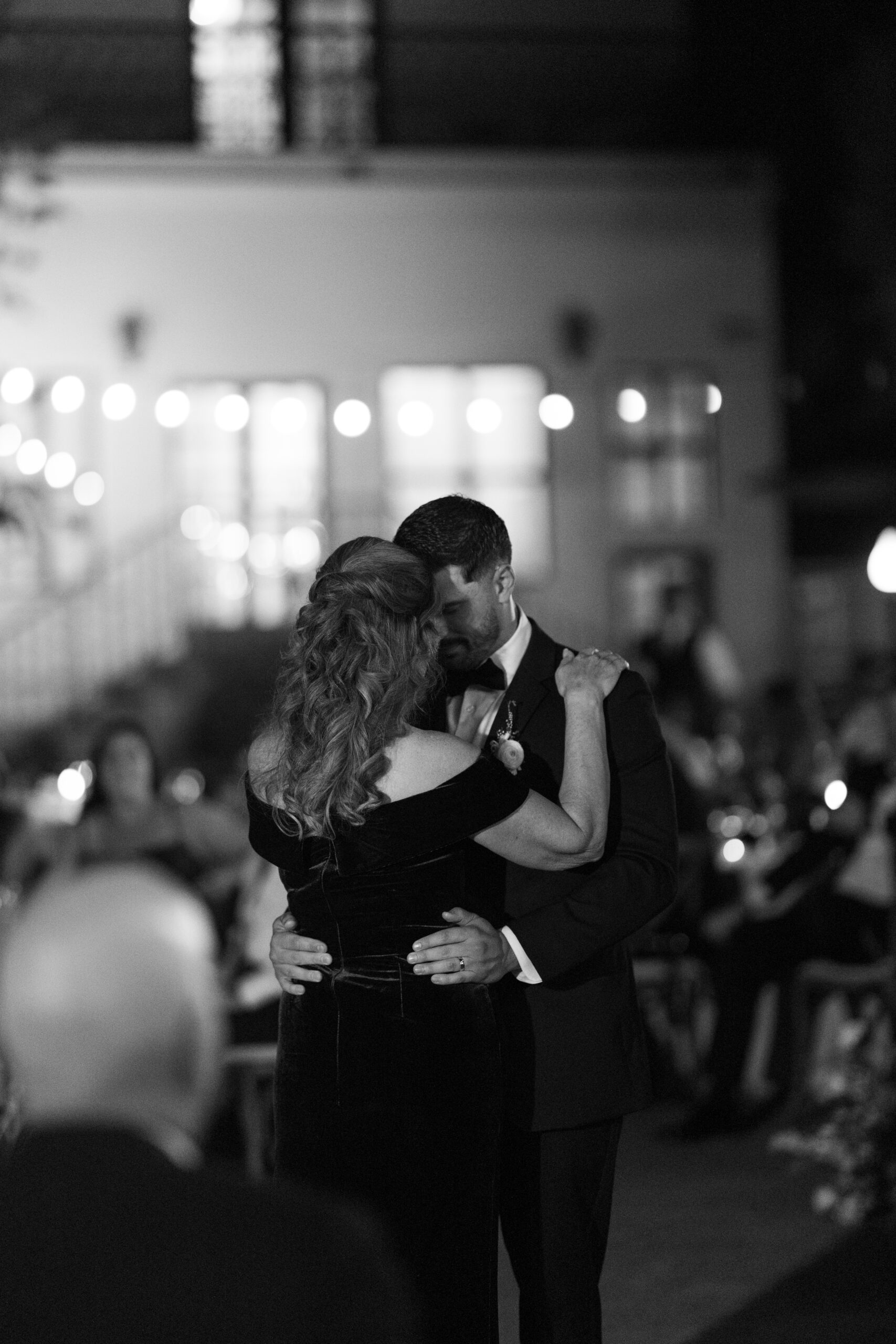 A groom and his mother dancing at a wedding reception