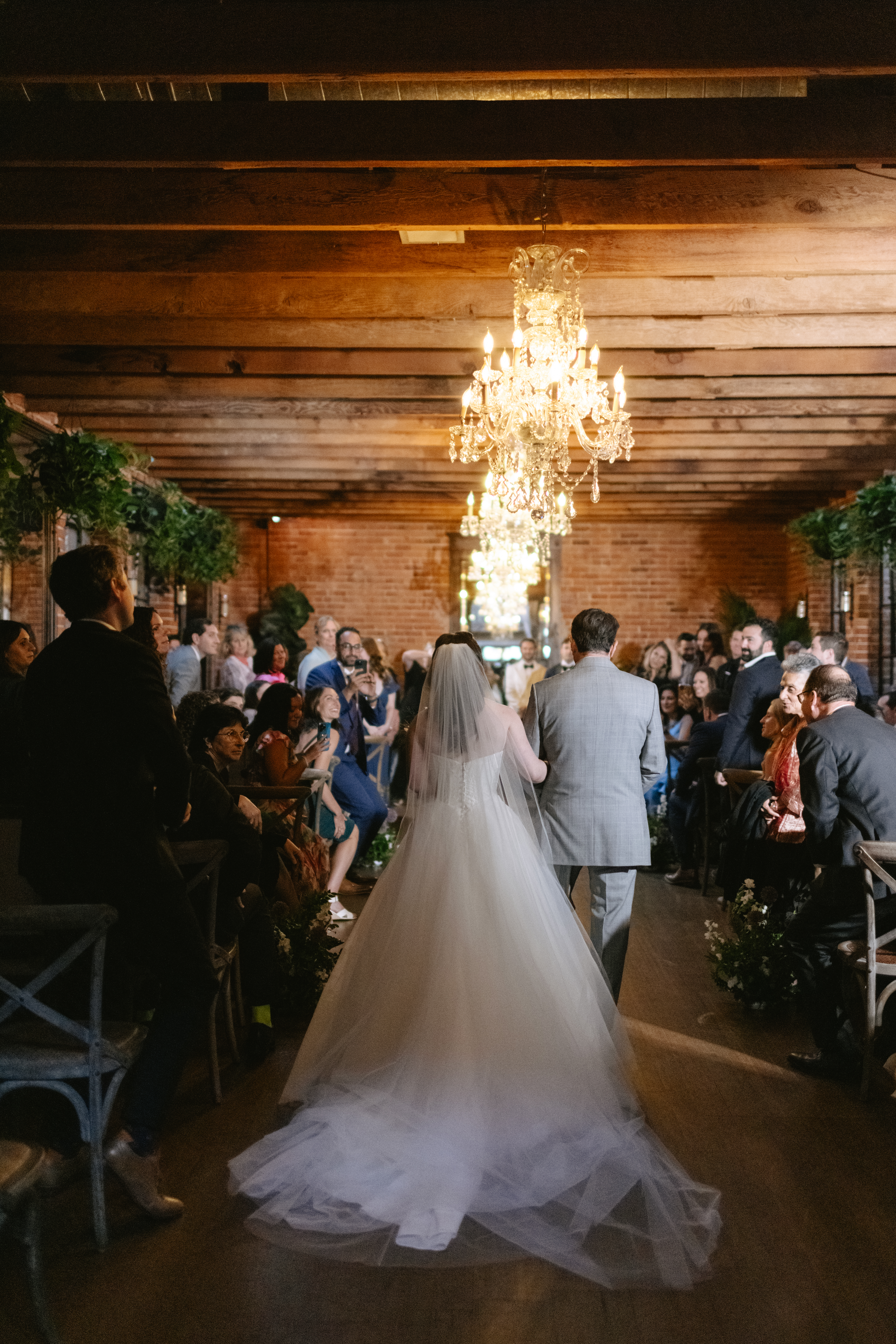 A bride walking down the aisle for her carondelet house wedding ceremony