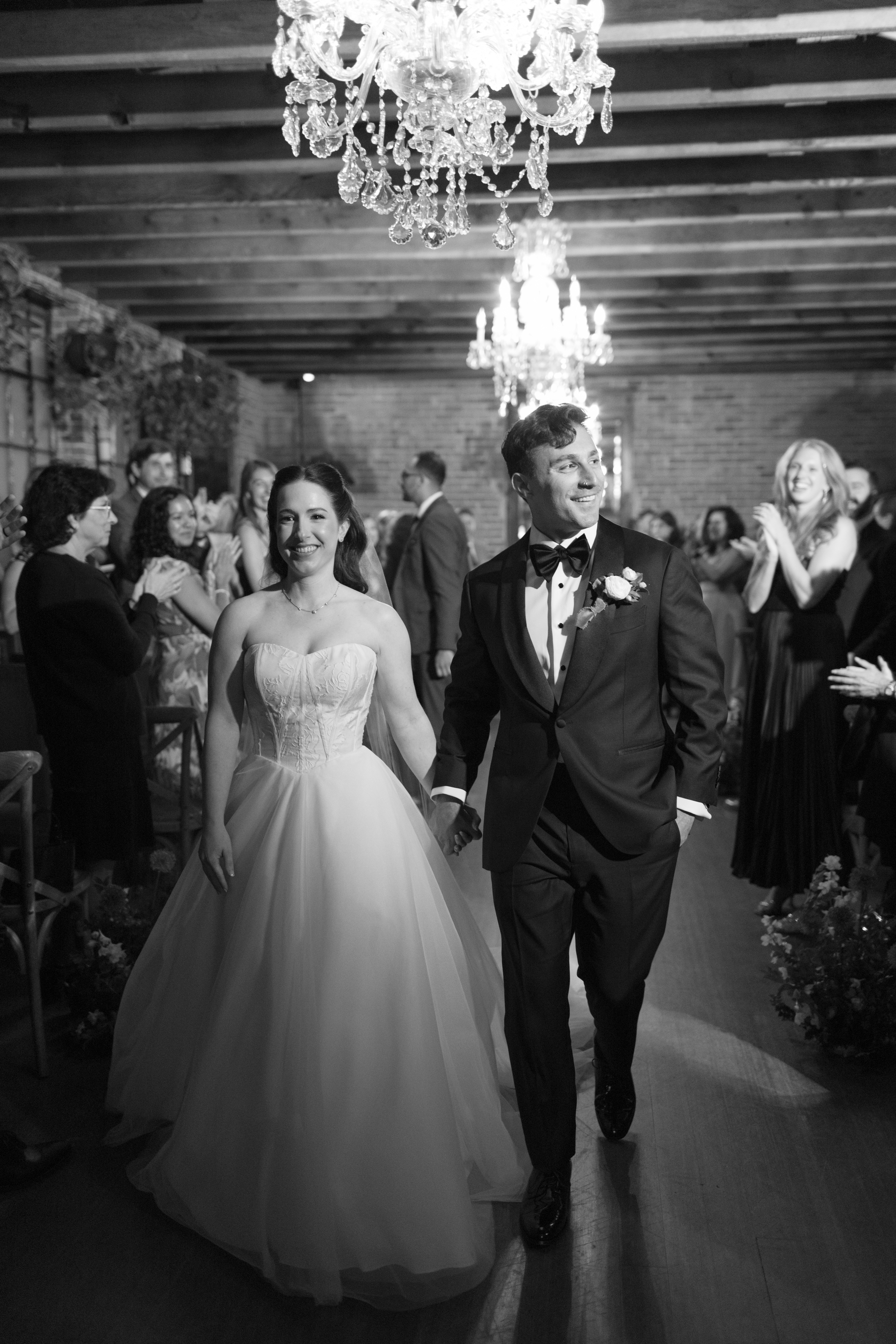 A wedding couple exiting the aisle after their wedding ceremony