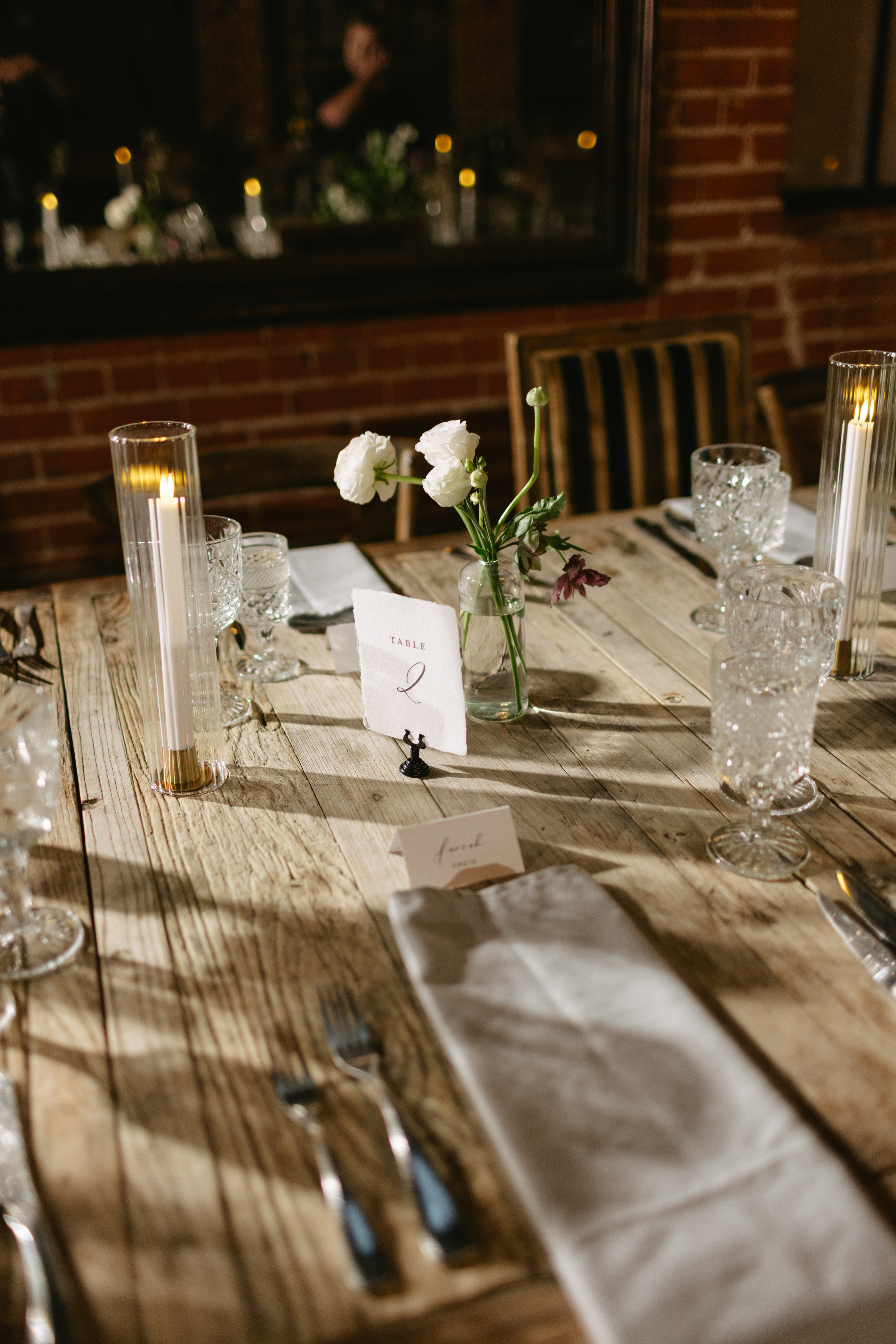 A wedding reception table setup at the Carondelet House with a floral centerpiece