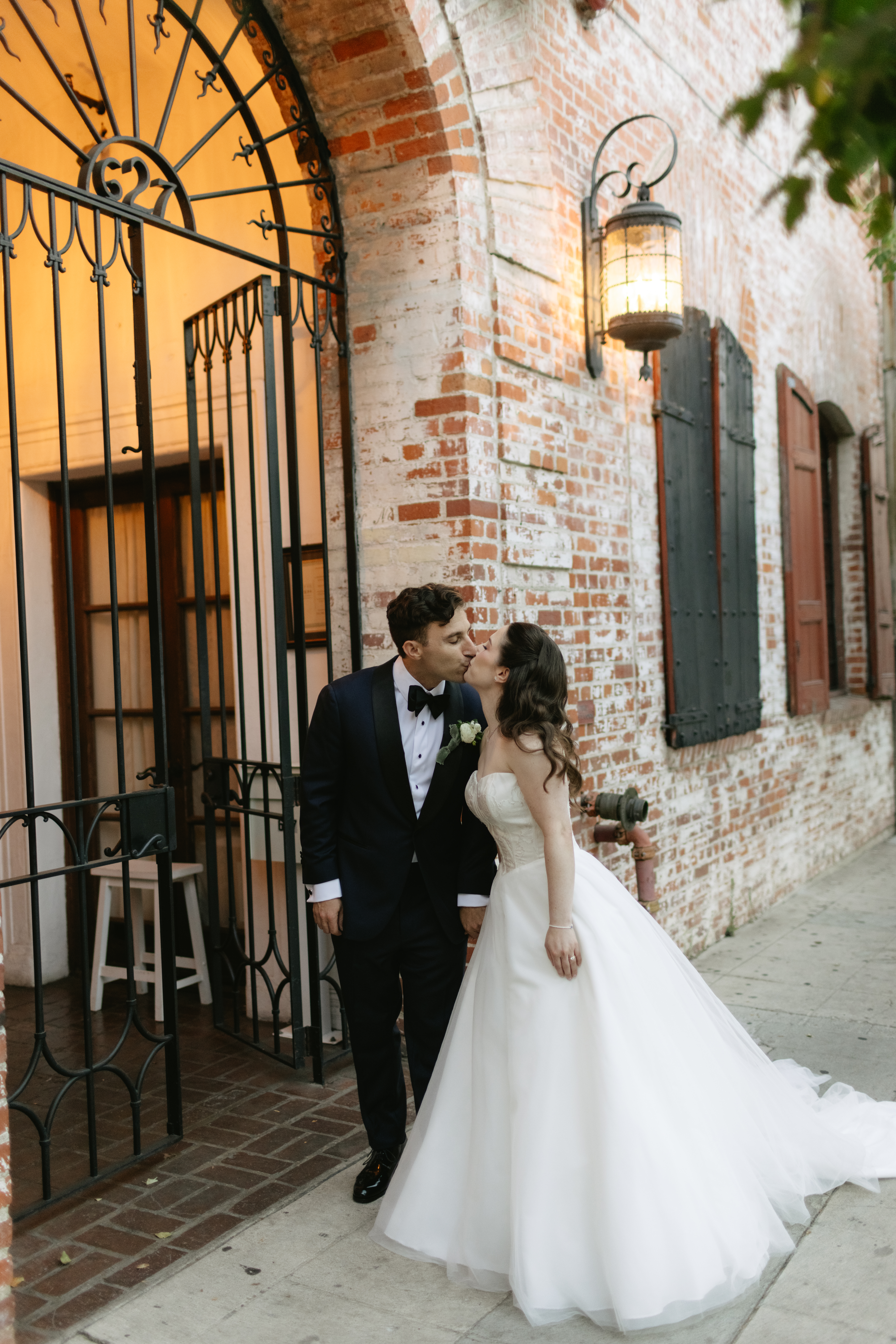 A couple kissing outsode of their los angeles wedding venue, the carondelet house