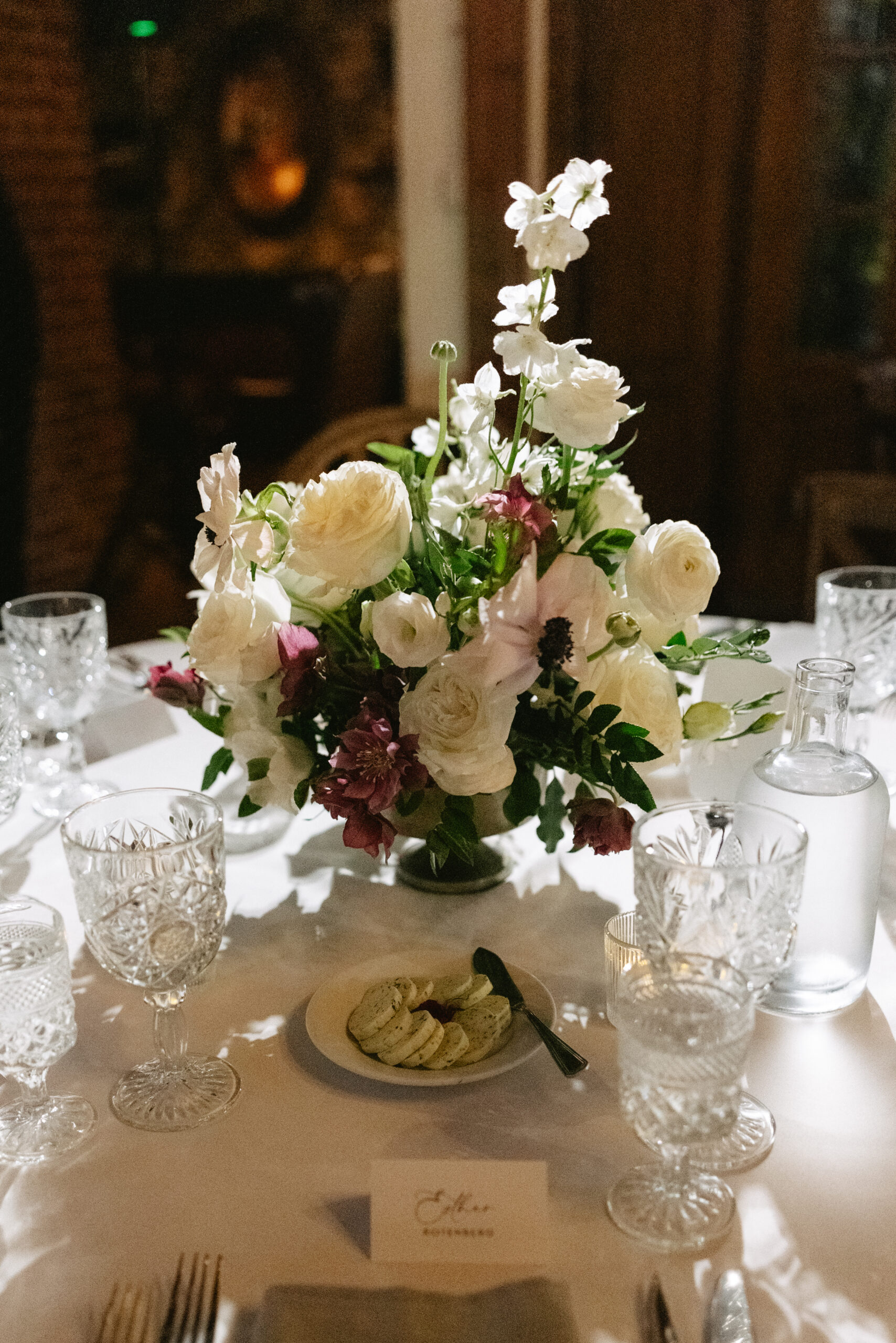 A wedding reception table setup at the Carondelet House with a floral centerpiece