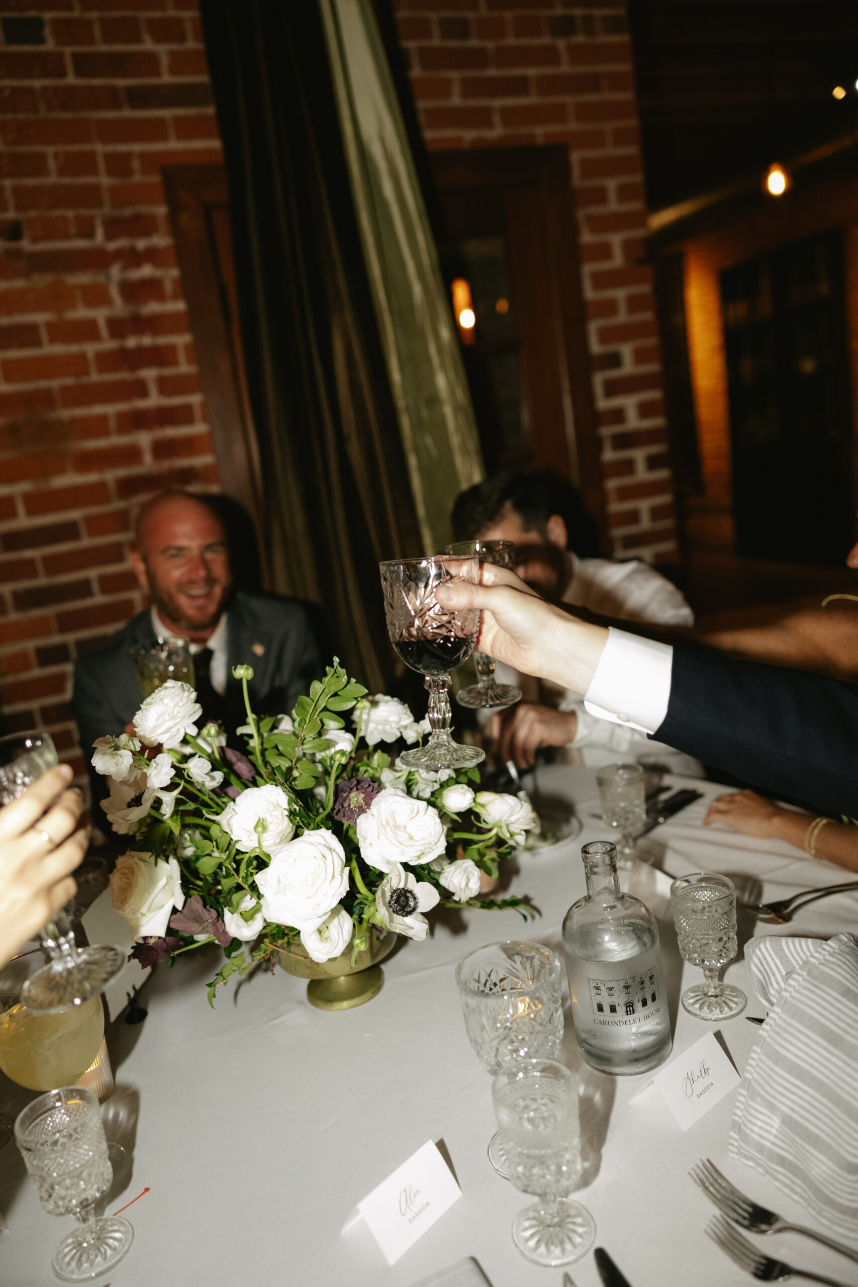 Guests raising their glasses for a toast at the Carondelet house