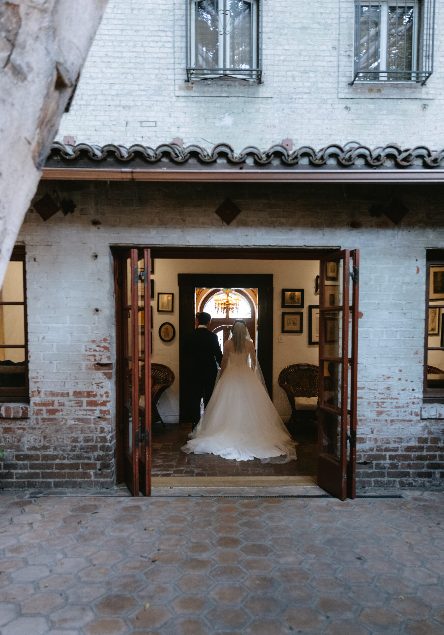 A couple walking into their Los Angeles wedding venue, the Carondelet House