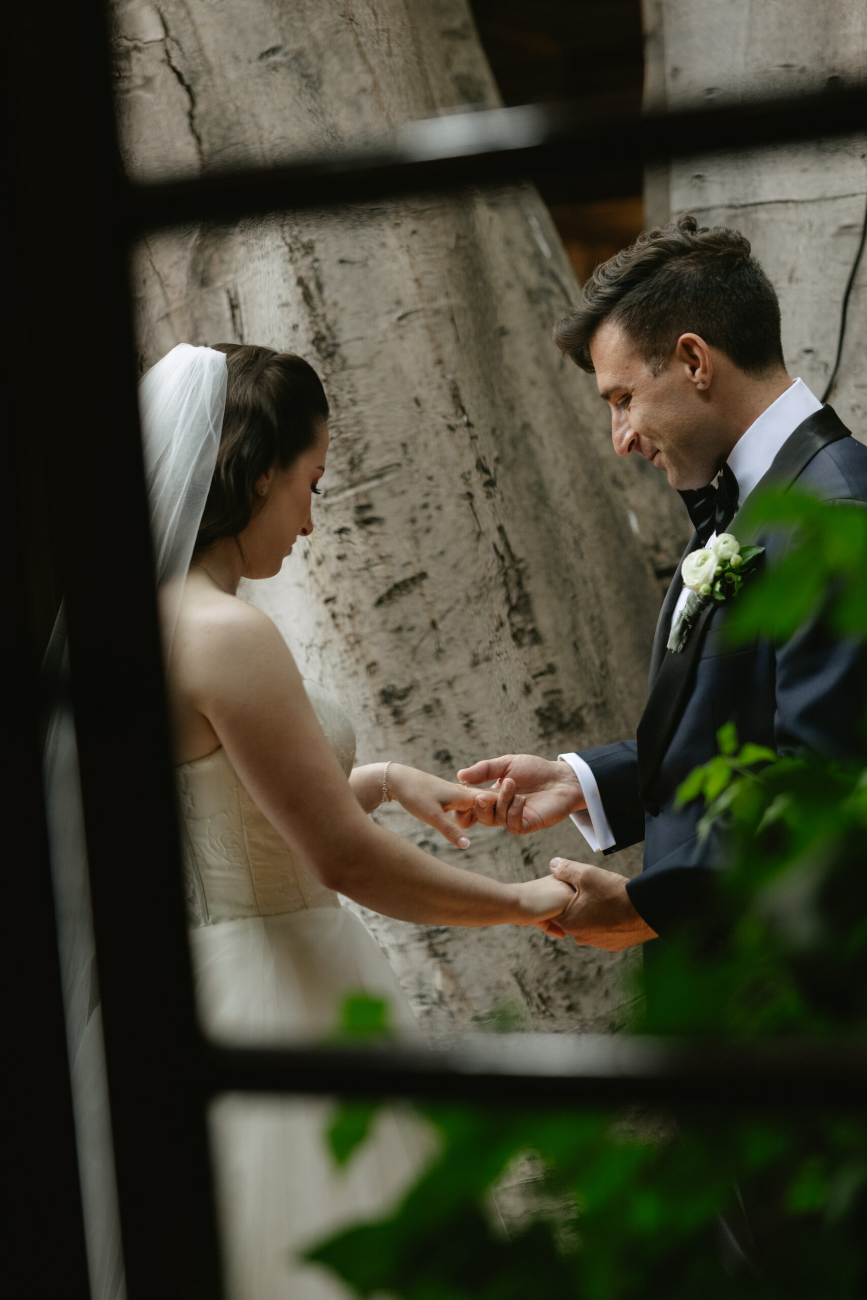 A bride and groom holding hands during a first look, captured through documentary style wedding photography