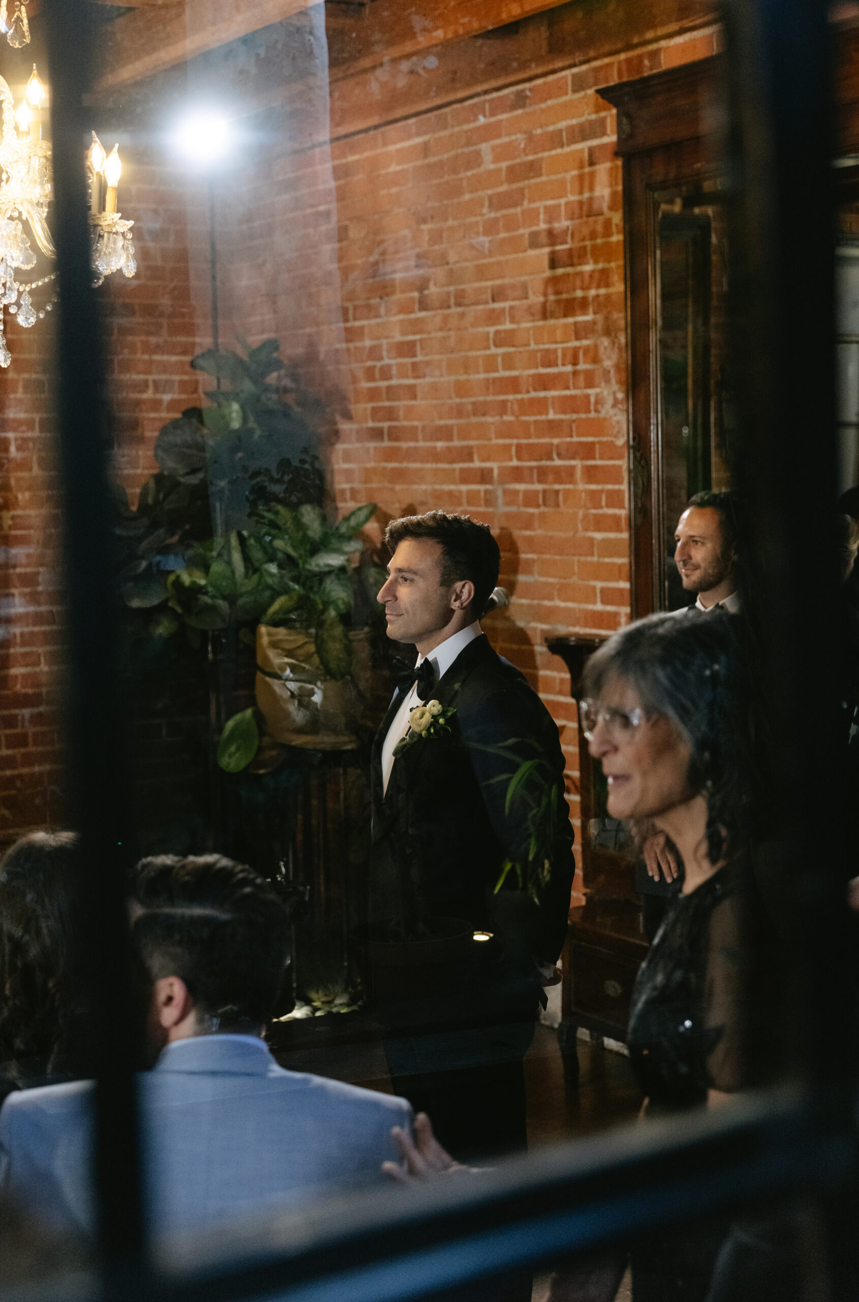 a groom wathcing a bride walk down the aisle
