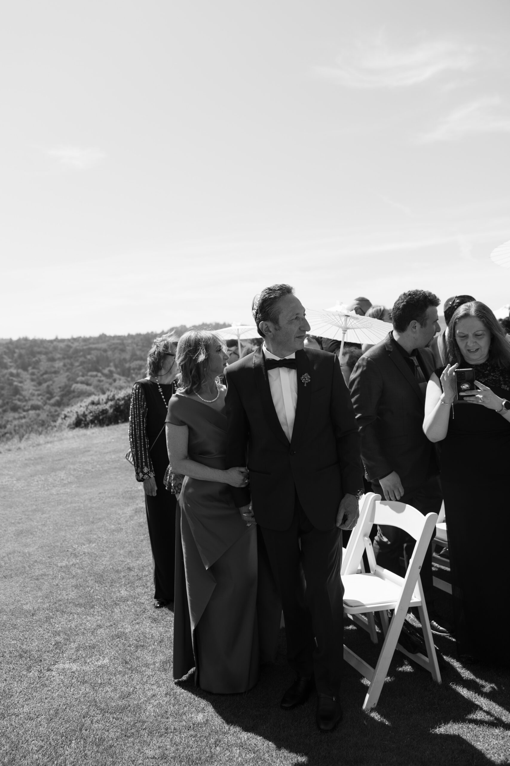 Wedding guests watching the bride walk down the aisle