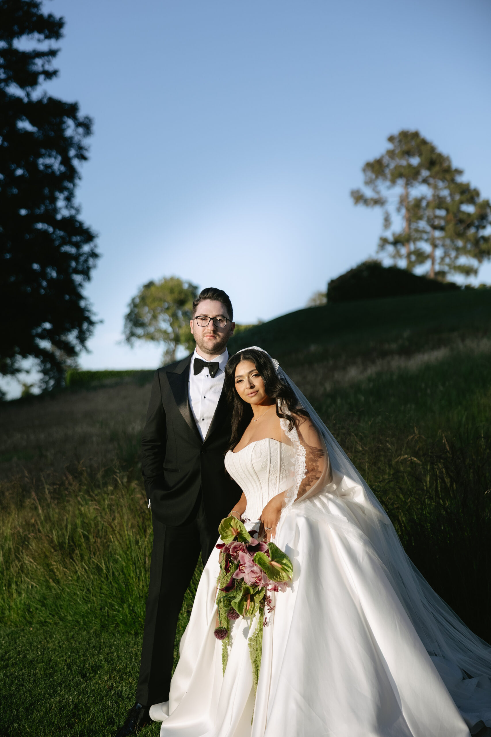 A bride and groom posing for portraits at the Peninsula Golf and country club