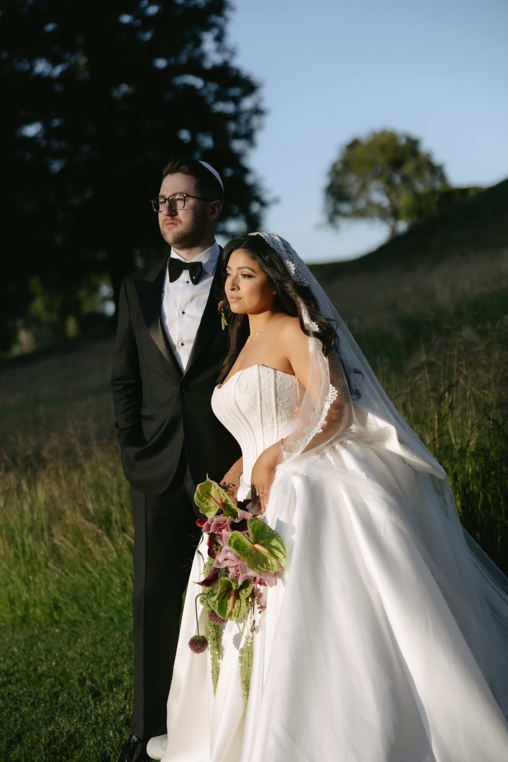 A bride and groom posing for portraits at the Peninsula Golf and country club