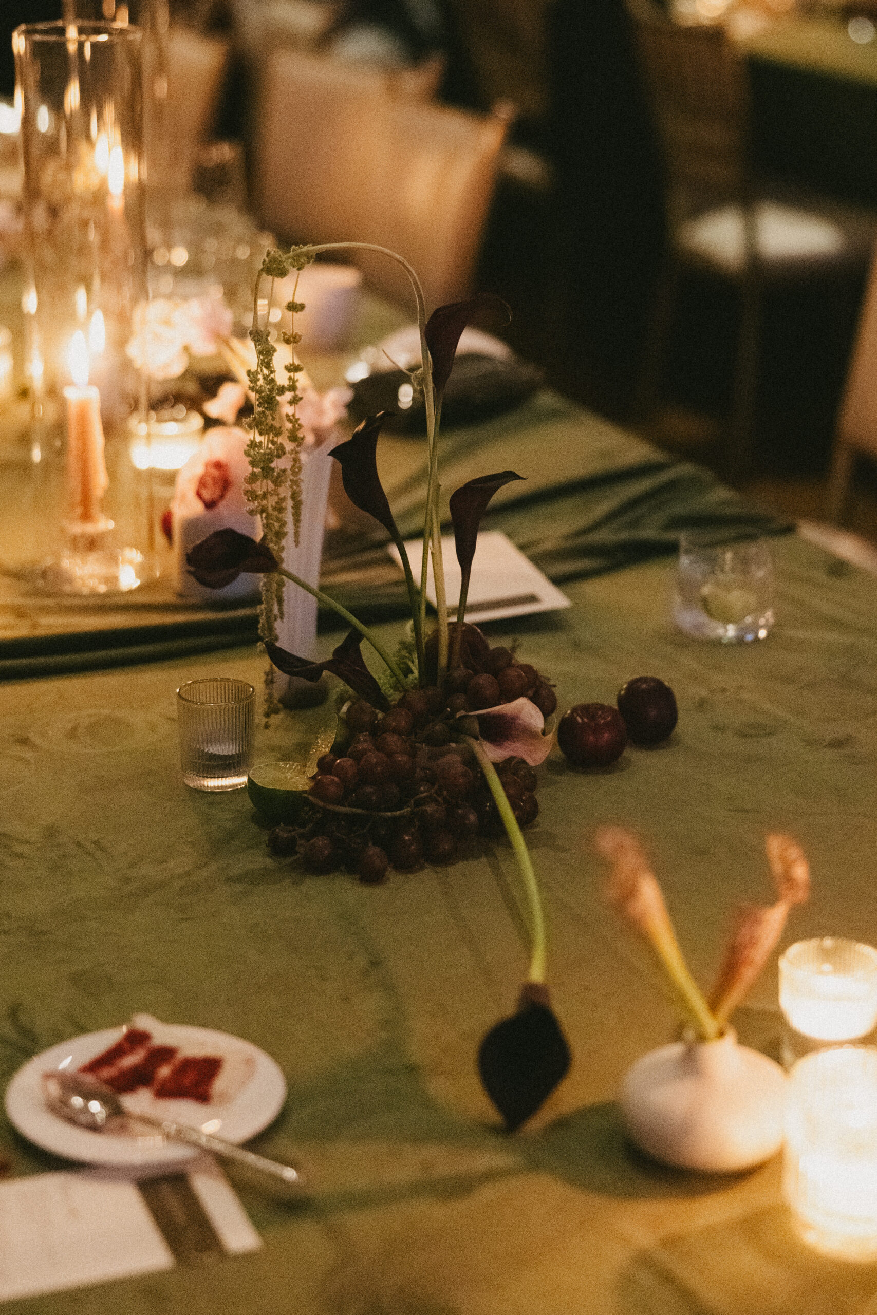 A candlelit wedding reception with fruit centerpieces