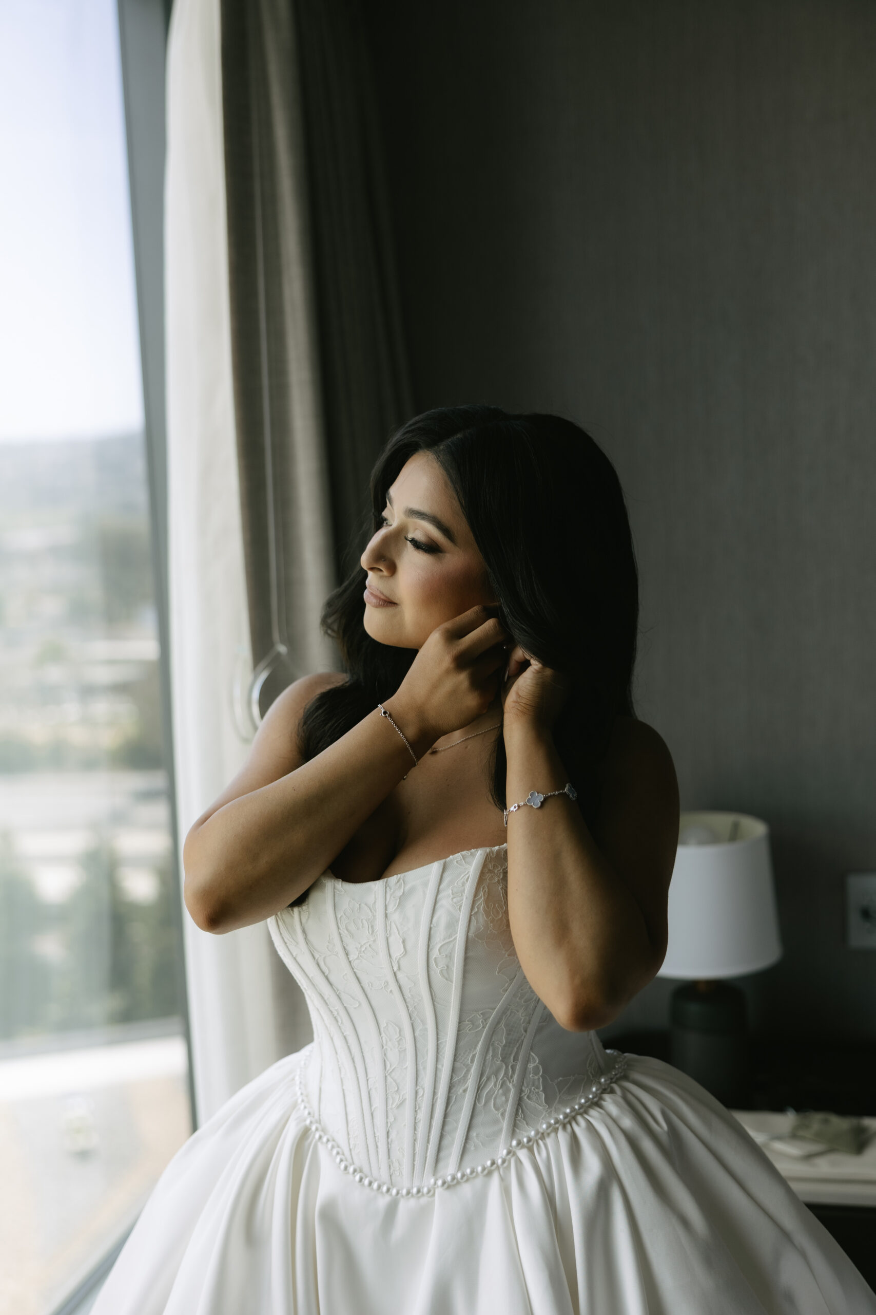 A bride in a luxury wedding dress in getting ready wedding photos