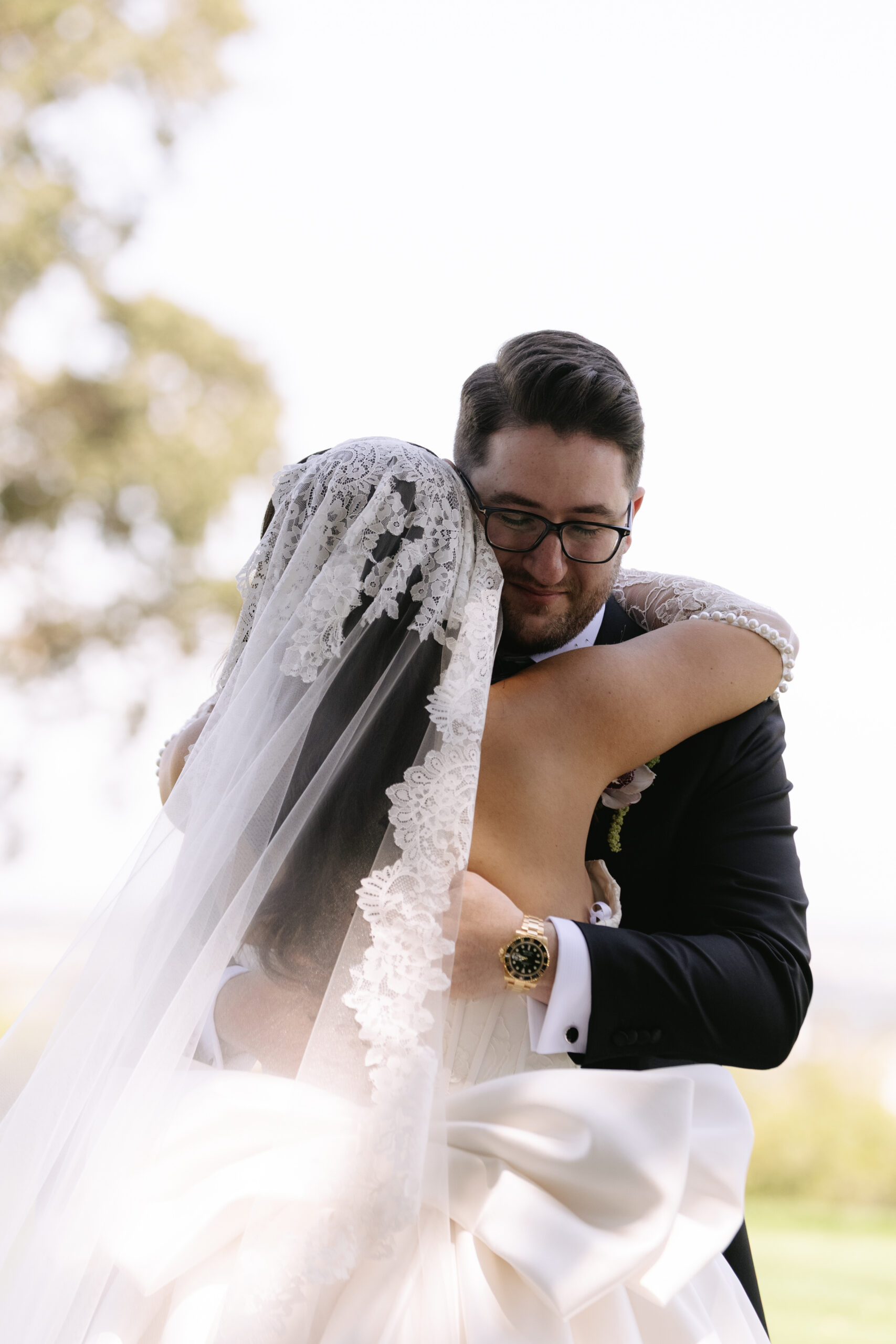 A bride and groom hugging in a candid wedding photo
