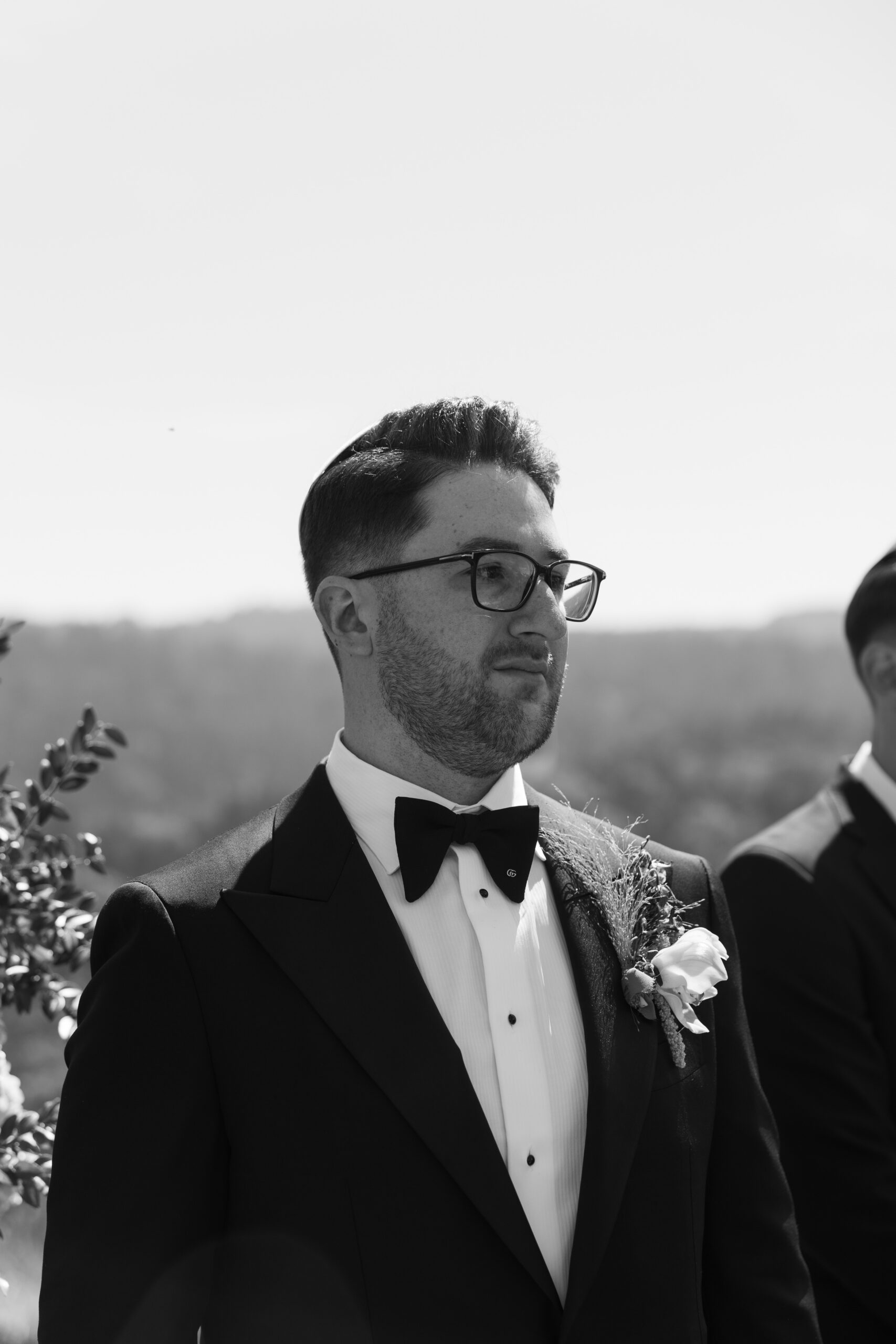 A groom watching the bride walk down the aisle